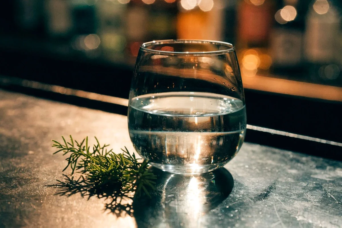 London Dry Gin in a glass on a bar top.