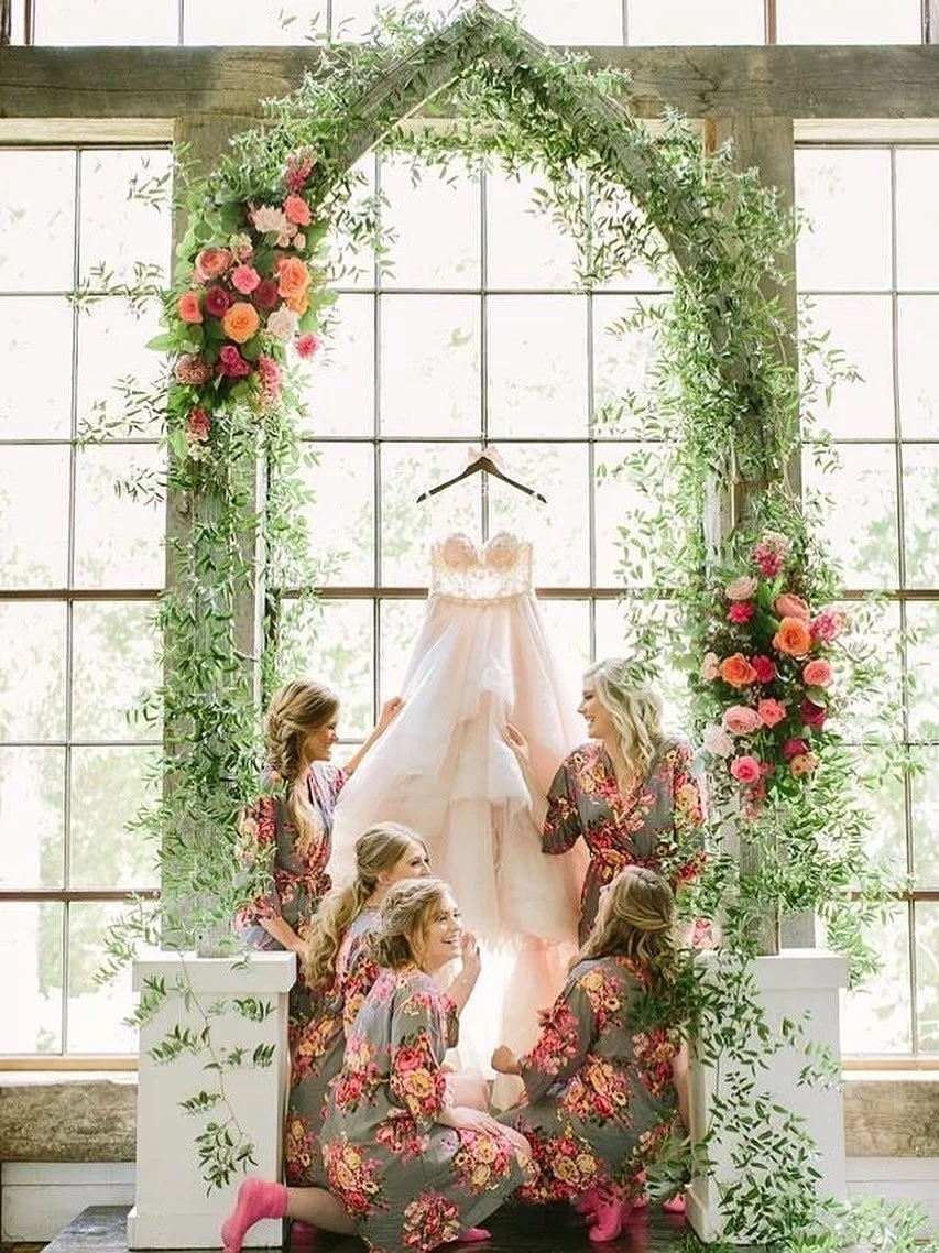 Before the walk down the aisle came this moment&mdash;bridesmaids gathered, the dress ready, and our Farmhouse Arbor completing the picture. Pure magic. 🤍