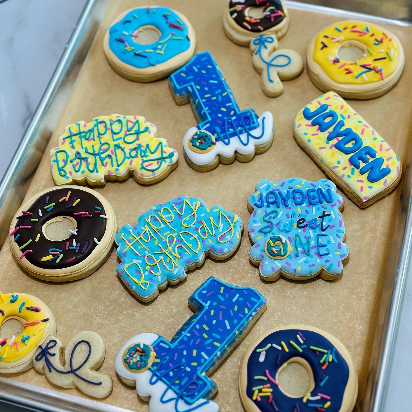 Is it a cookie or a donut? Why not both! Happy first birthday to Jayden, who is obviously a sweet one. #SugarCookies #Homemade #RoyalIcing #CustomCookies #HandDecoratedCookies #DecoratedCookies #DecoratedSugarCookies #CookieArt #EdibleArt #CookiesOfI