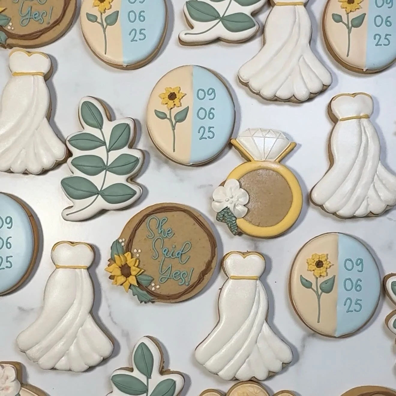 I&rsquo;m obsessed with how this sunflower-inspired bridal shower set turned out! From the shimmery gowns to the little leafy details and that perfect engagement ring cookie, everything came together so sweetly. The wedding date cookies might be my f
