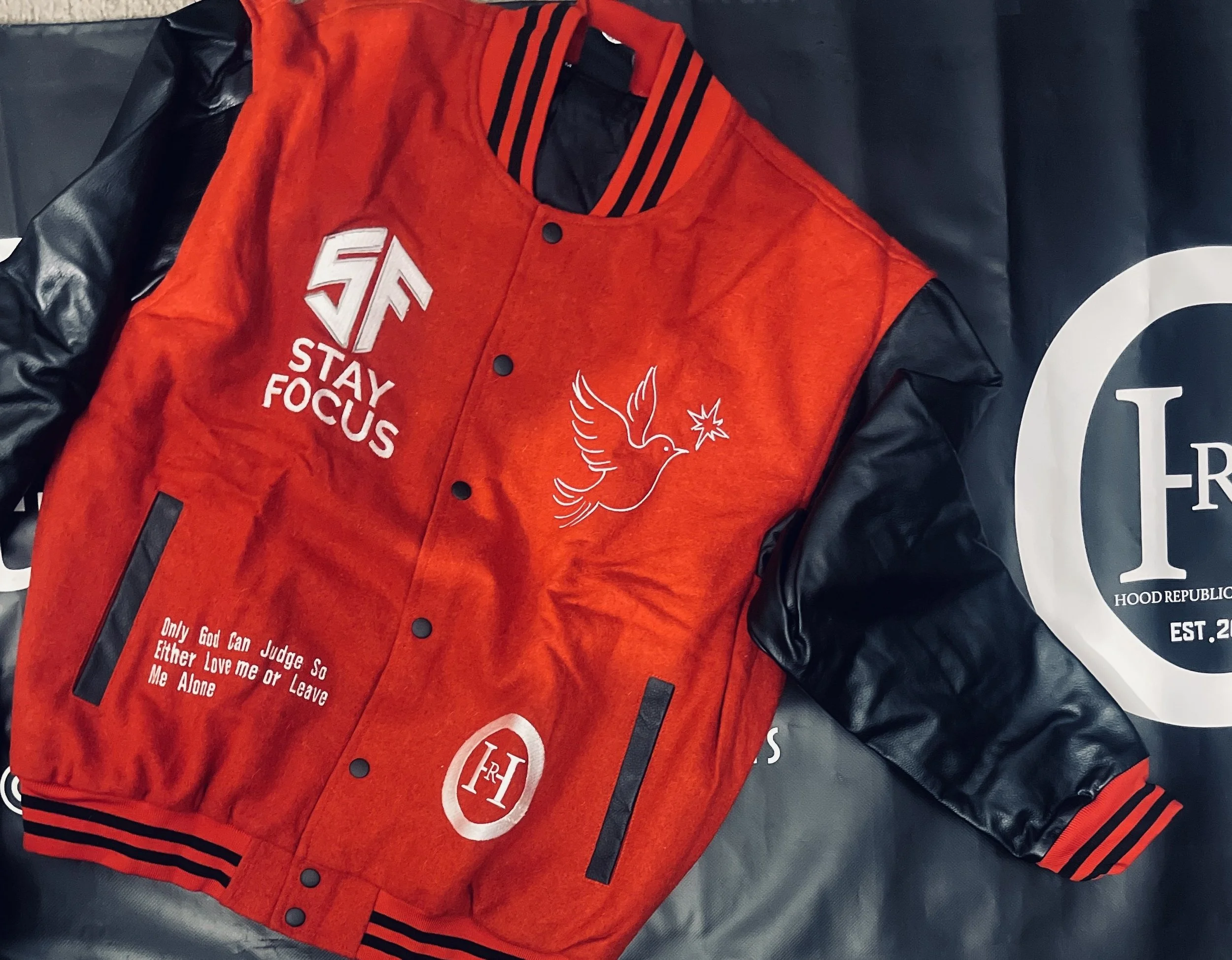 her lip to H Logo Varsity Jacket H.R.O Varsity Jacket — Hood