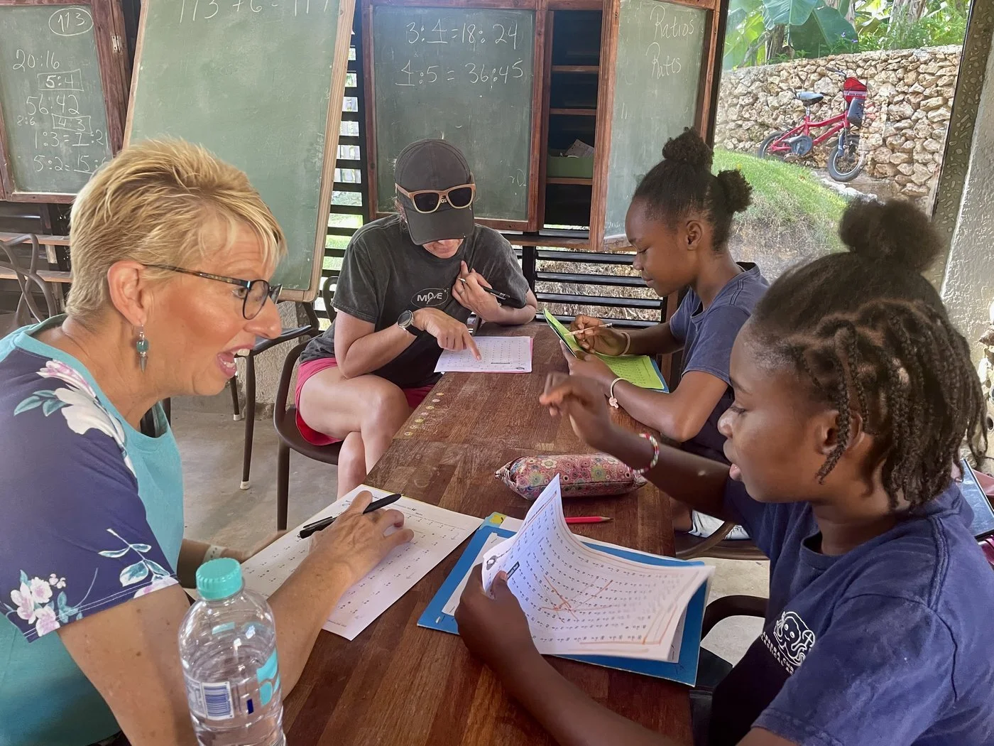 Teaching team member working through math with students