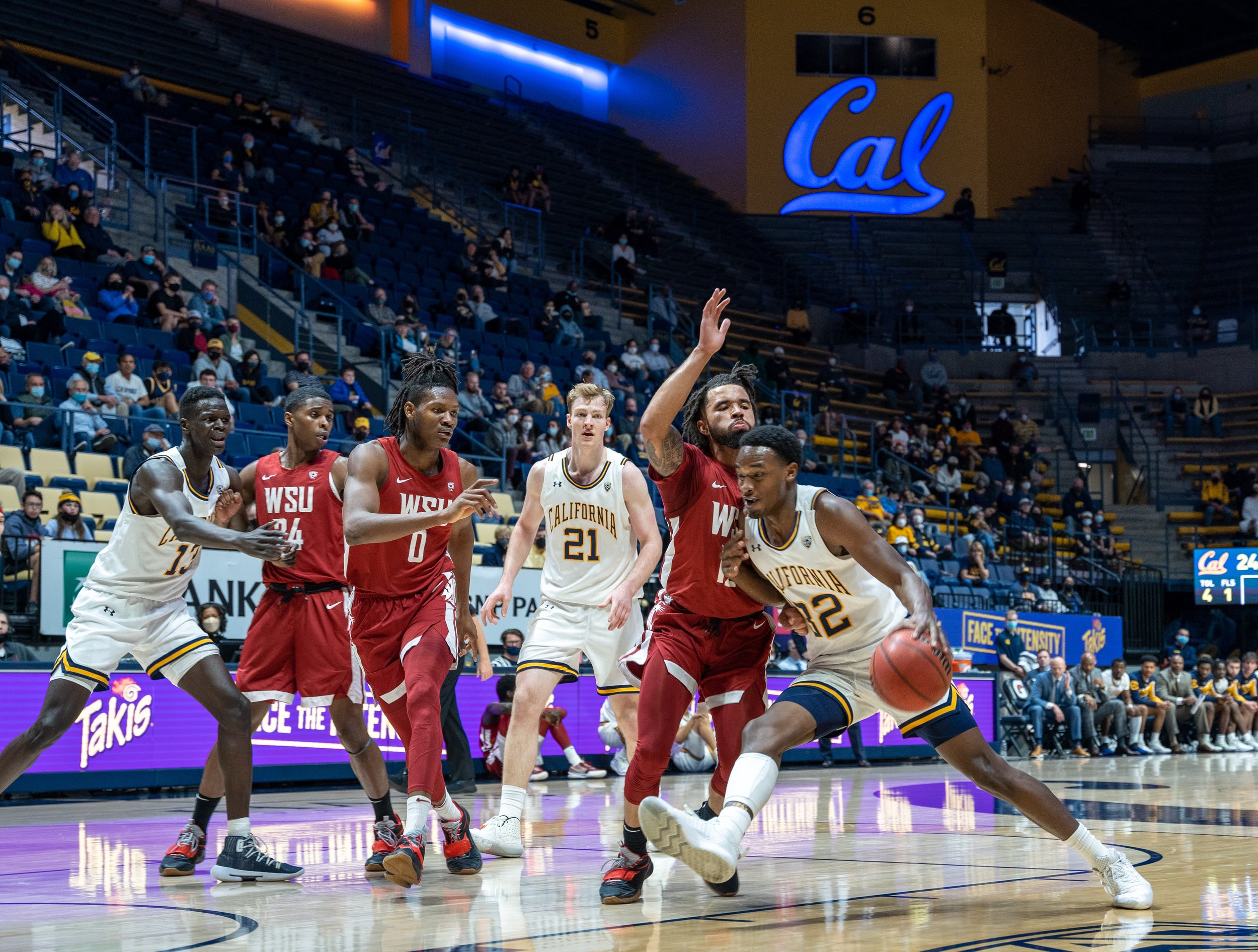 Pac-12 Basketball Cal's Jalen Celestine dribbling through WSU's defense towards the basket.