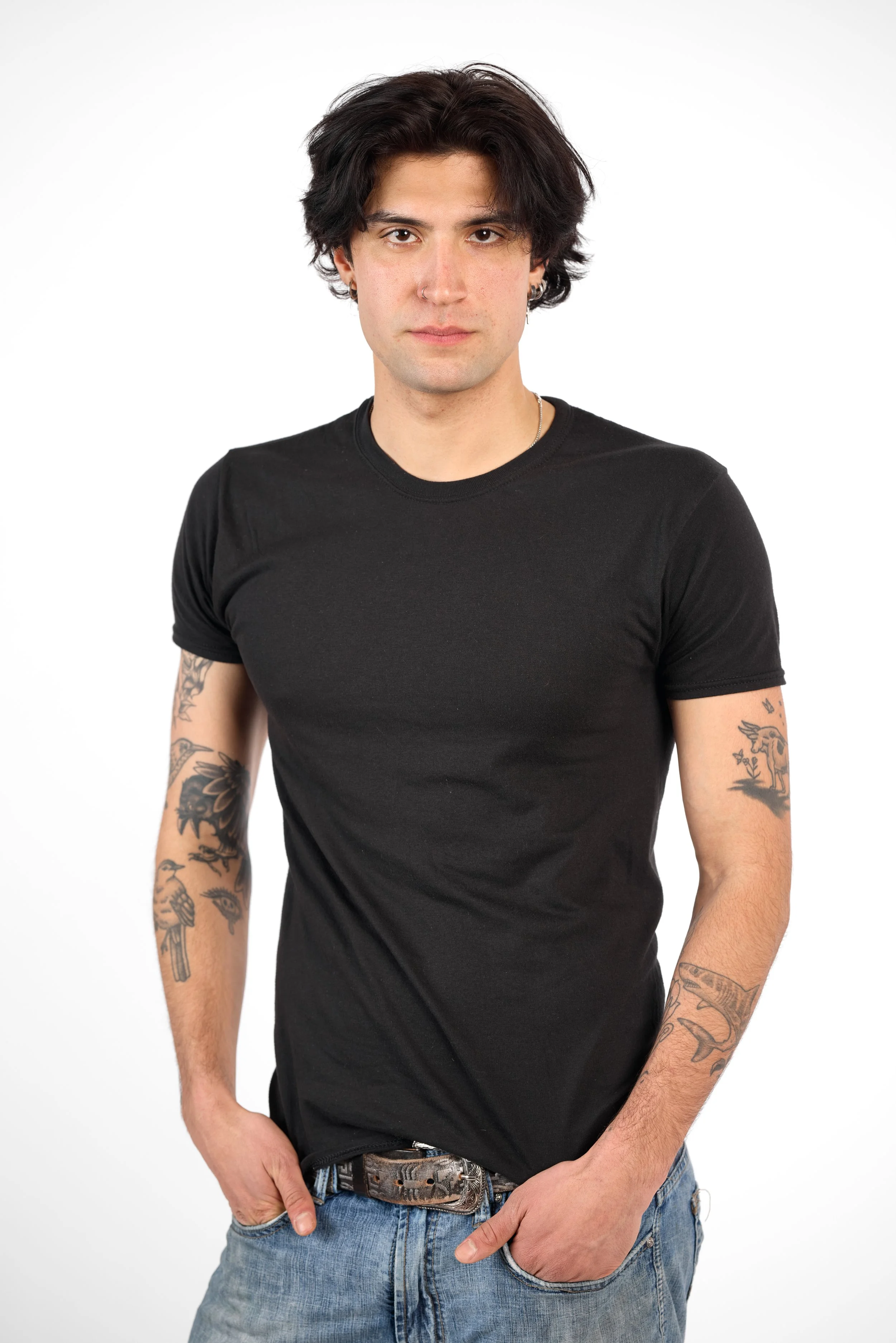 Chicago Modelling Digital of a young man with black hair, wearing a black t-shirt and blue jeans, standing against a white background.