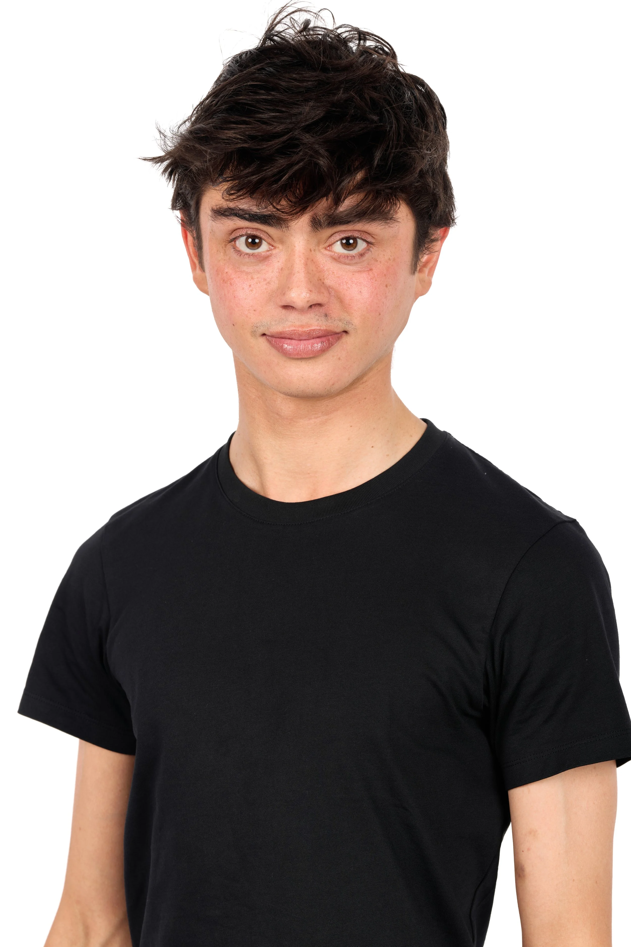 Chicago studio modeling digitals of a man with dark, tousled hair and light skin, wearing a black T-shirt, looking at the camera with a slight smile, against a white background.
