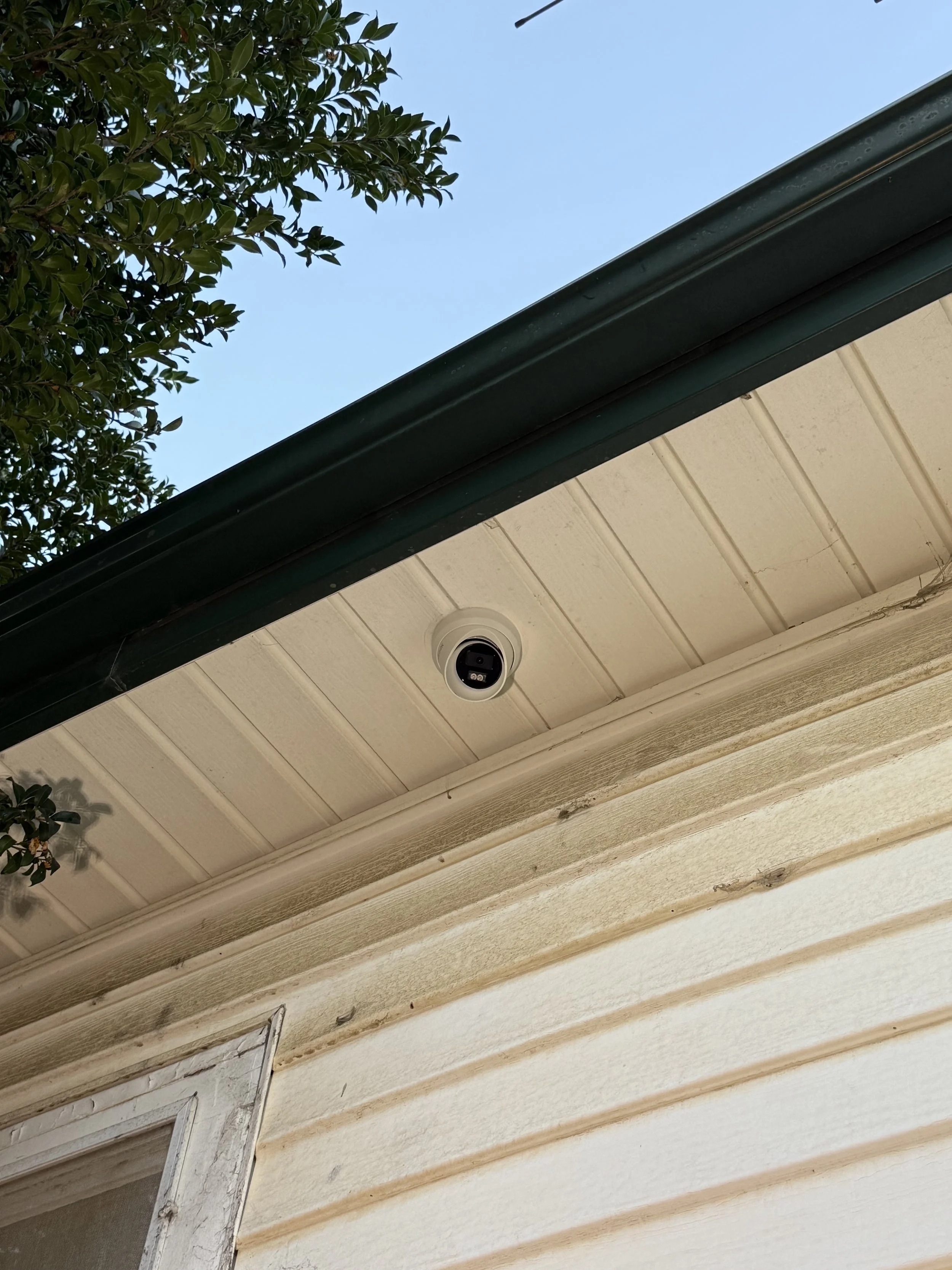 HiLook security camera installed on eave of a house.