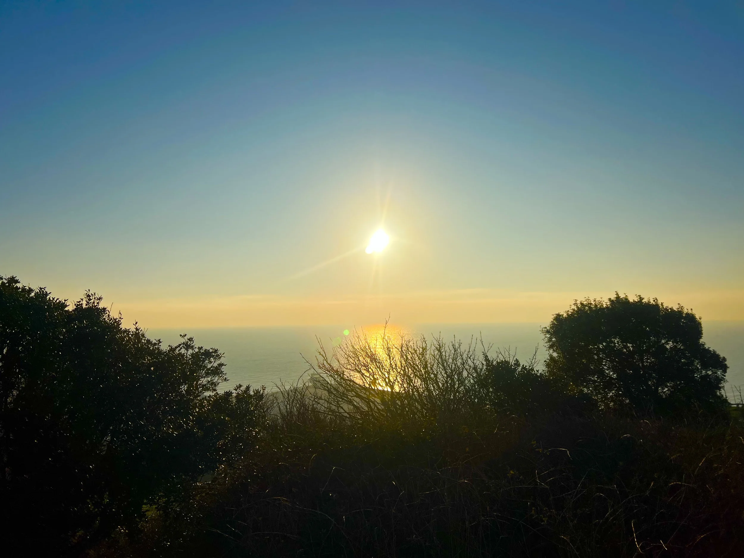 the sun setting over the sea