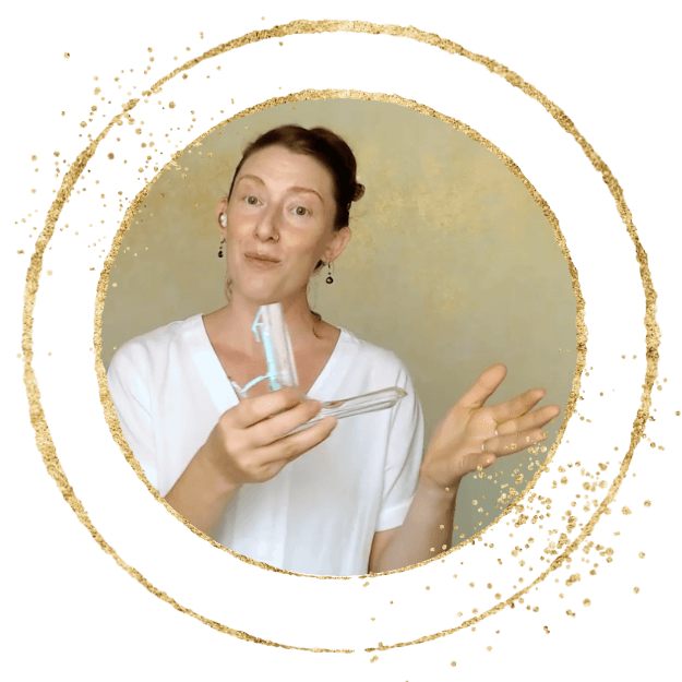 muse holds a plastic speculum and looks playfully at the camera