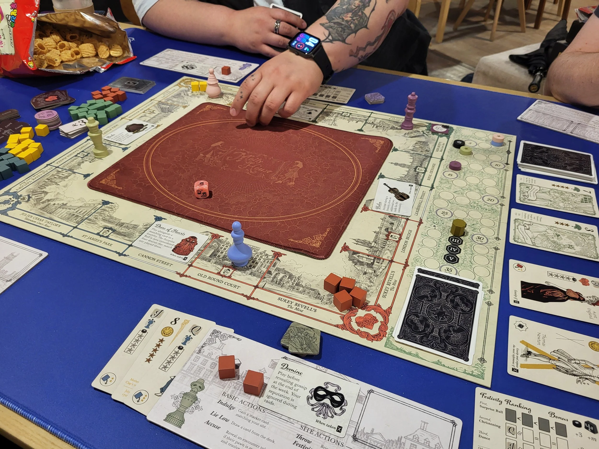 A photo of Molly House in play, with its attractive period appropriate art and weird looking little pawn guys.