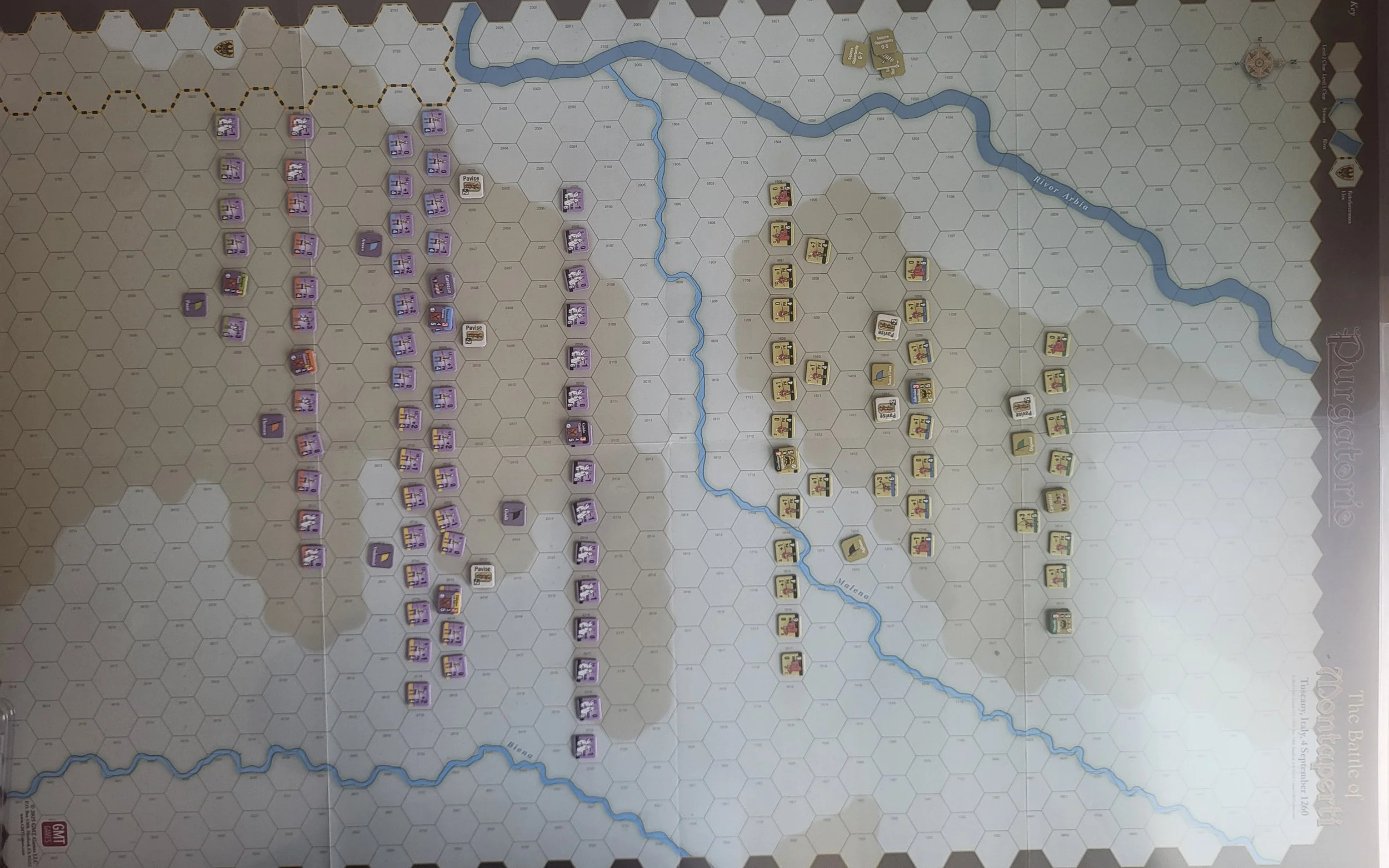 Photo of the initial set up for Montaperti, which has maybe 20-40 units per side with a river down the middle and hills on either side of the map.
