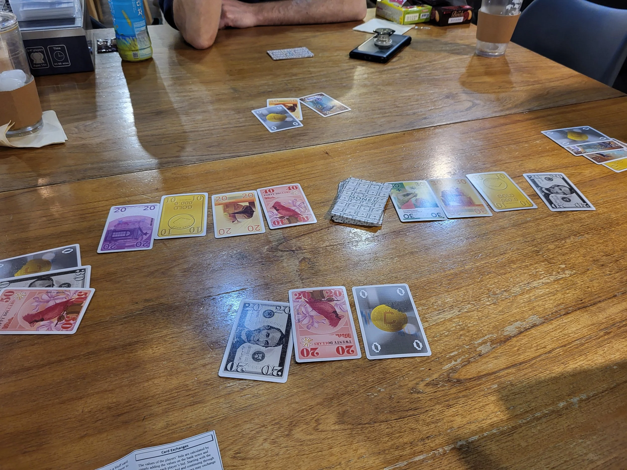 Picture of Money in play, the cards all have pretty facsimiles of real world money on them along with printed  values.
