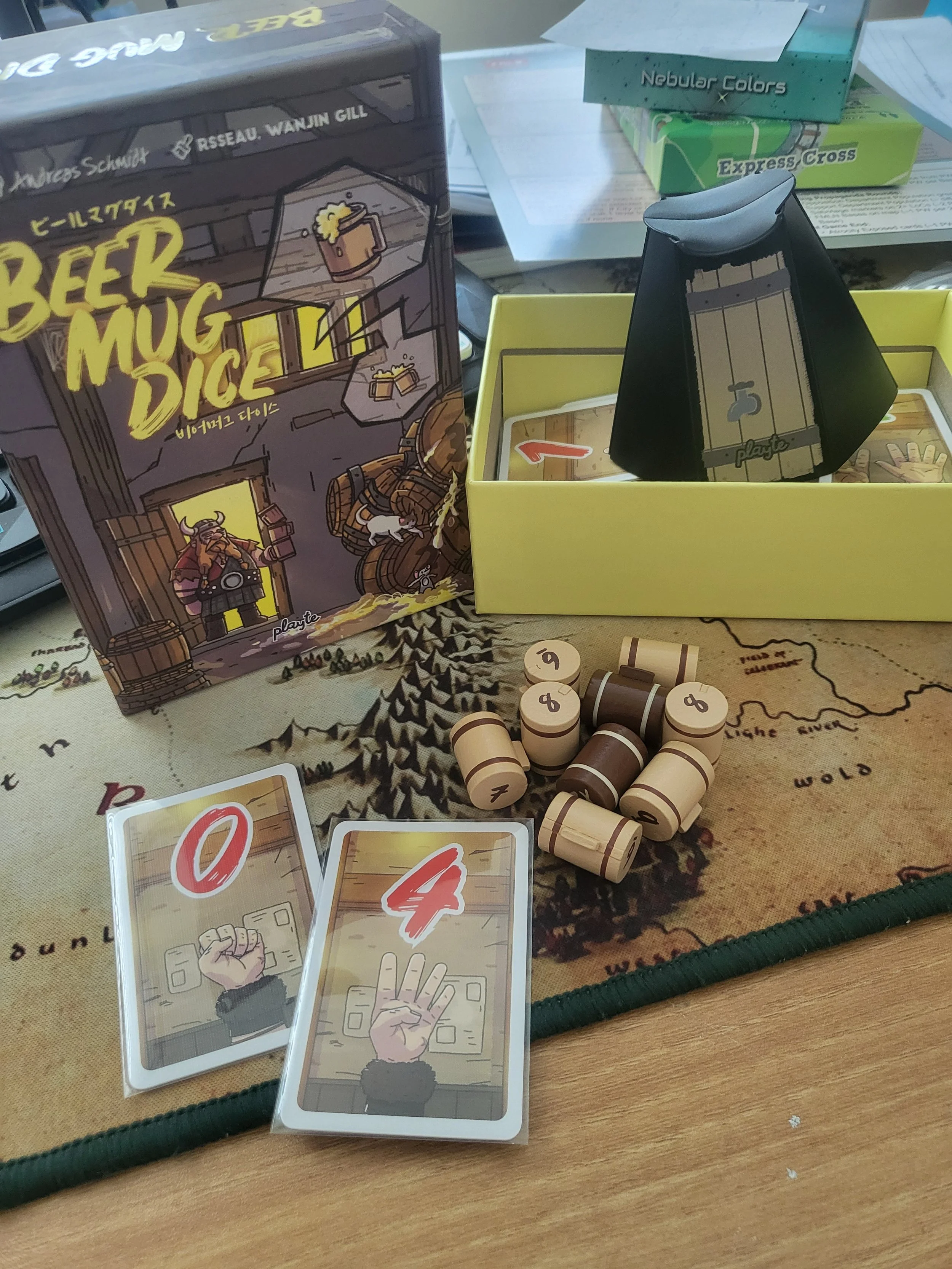 The components of Beer Mug Dice, including beer mug shaped dice in two colors, cards showing numbers and fingers, and a dice rolling cup