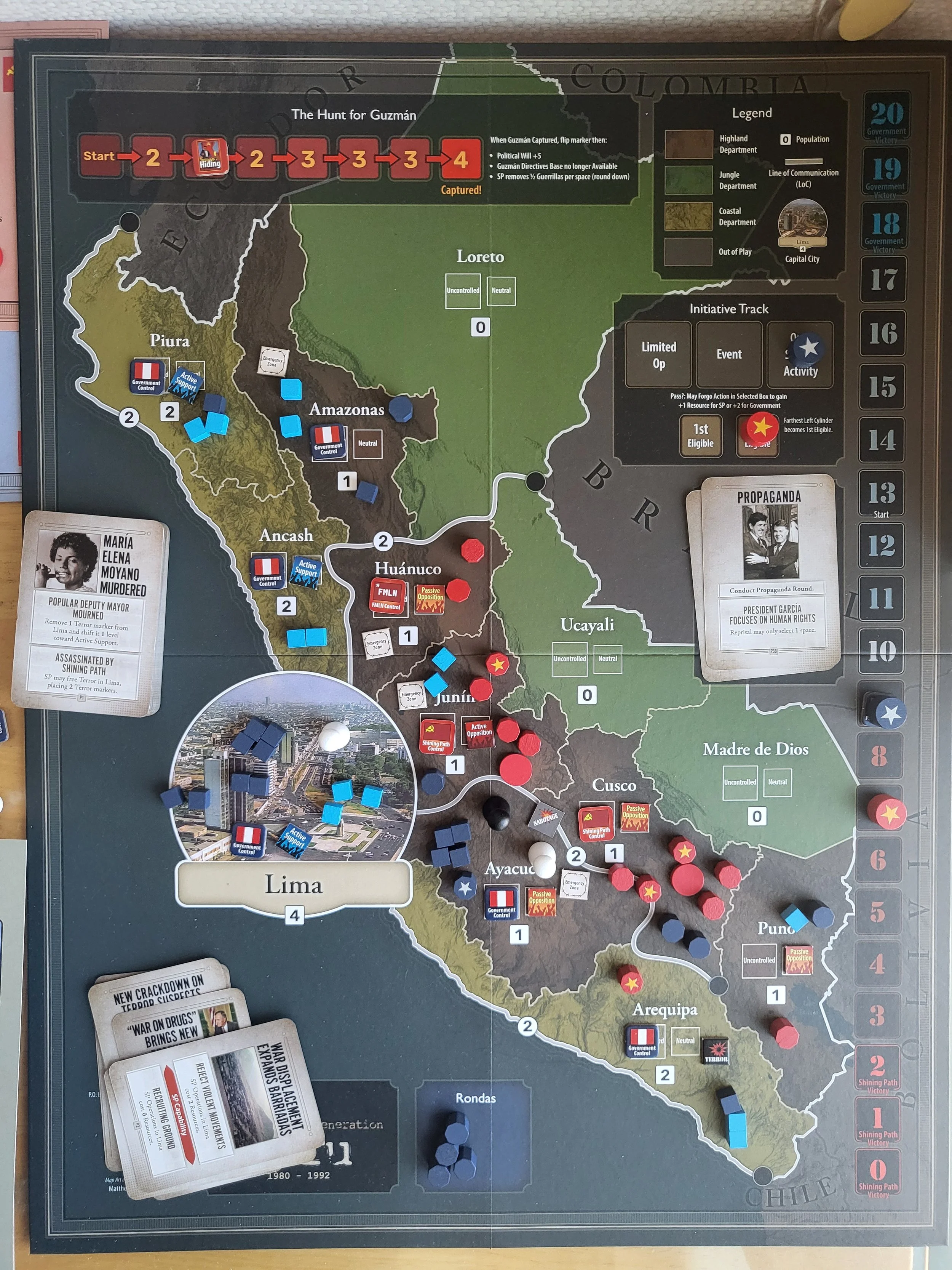 Photo of the Peru map about halfway through a game, with lots of pieces on the map.