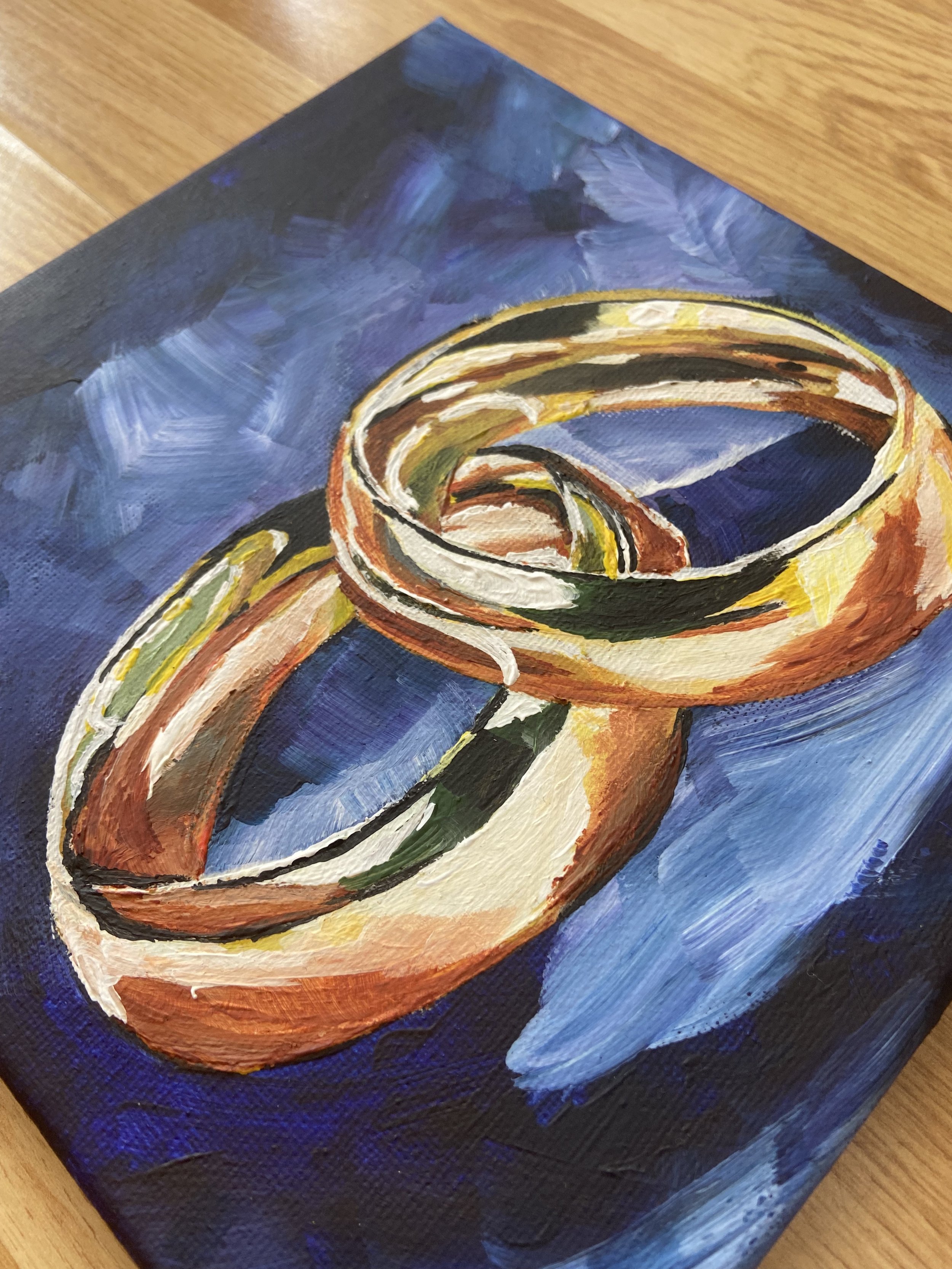 This art print is a perfect gift idea for a newly-wed couple close to your heart. The shiny gold colour of the rings just pops perfectly on the dark blue background.