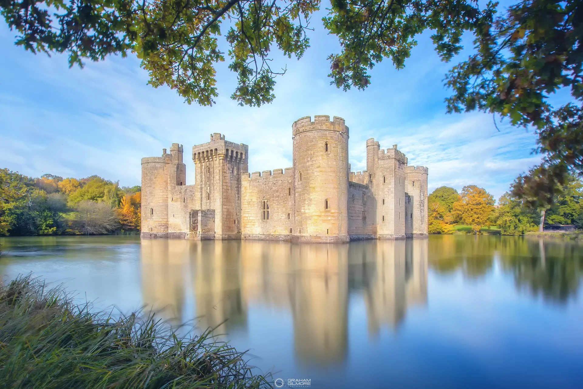 Bodiam Castle long exposure photograph at dusk, East Sussex England – minimalist landscape with still water reflection