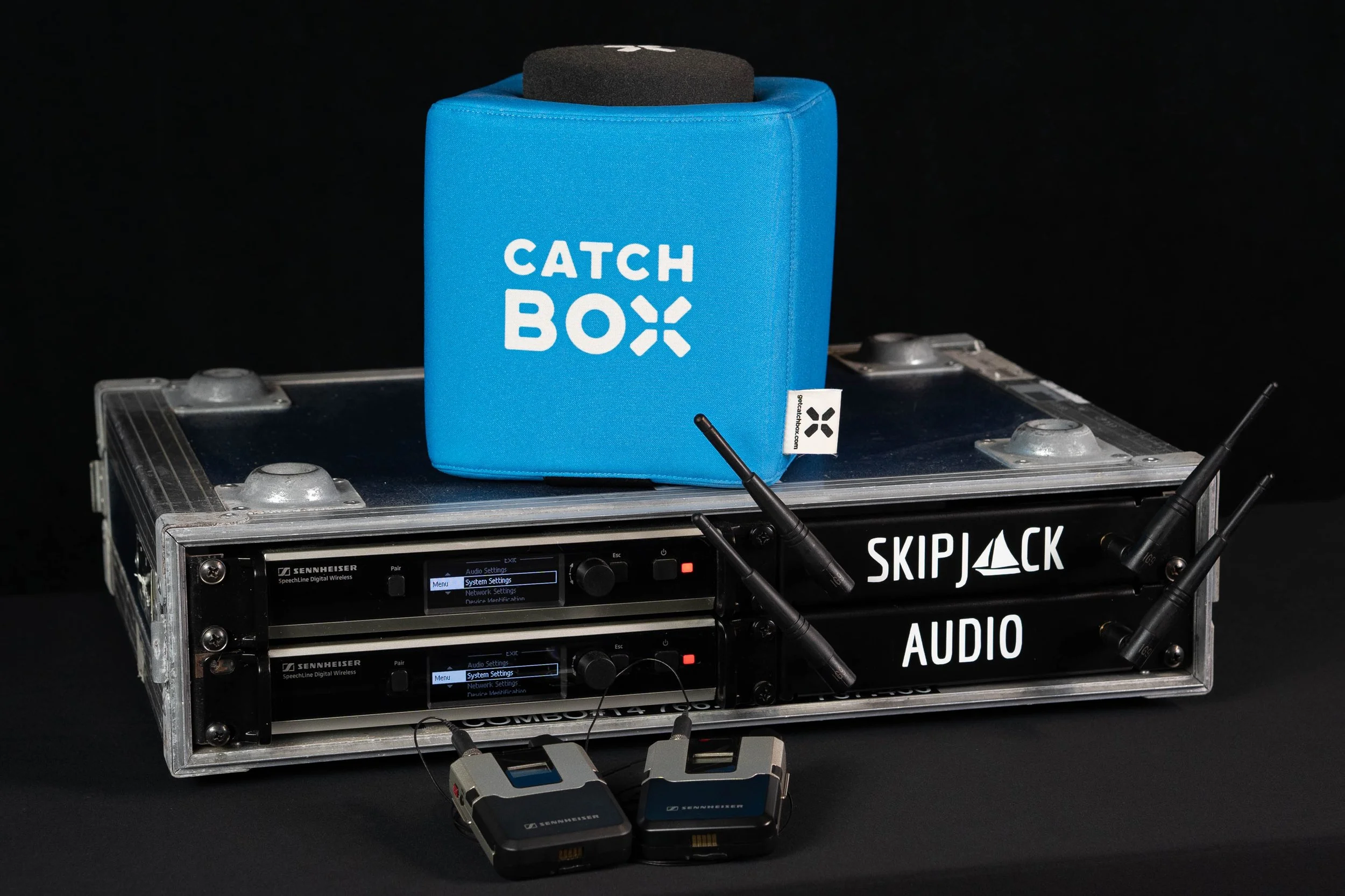 a set of 2 Sennheiser SpeechLine receivers in a rack case, alongside a catchbox throwable microhphone unit