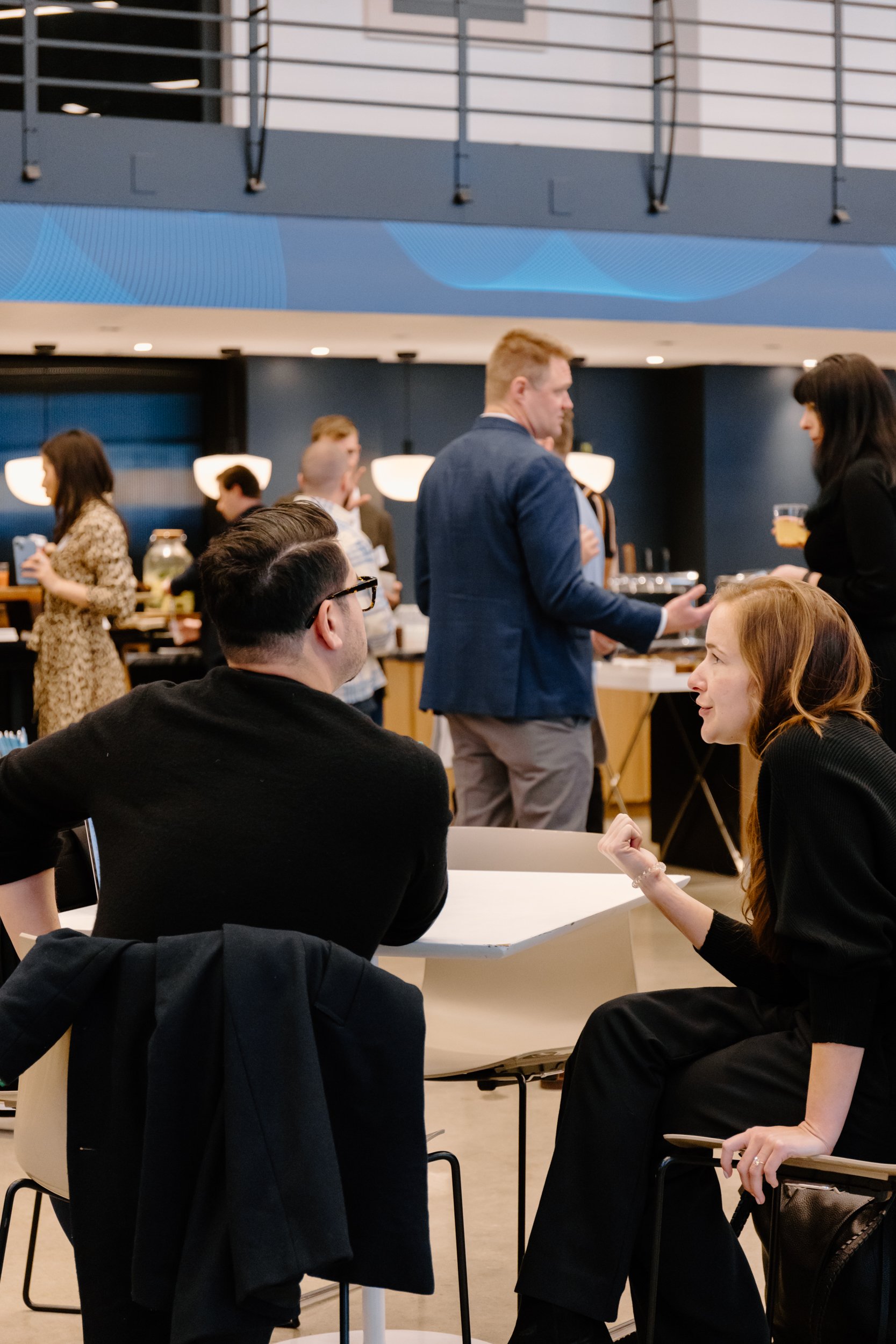 Professionals from pharma and ad tech exchanging insights during a networking session at DeepIntent’s healthcare marketing summit, photographed by corporate event photographer in NYC