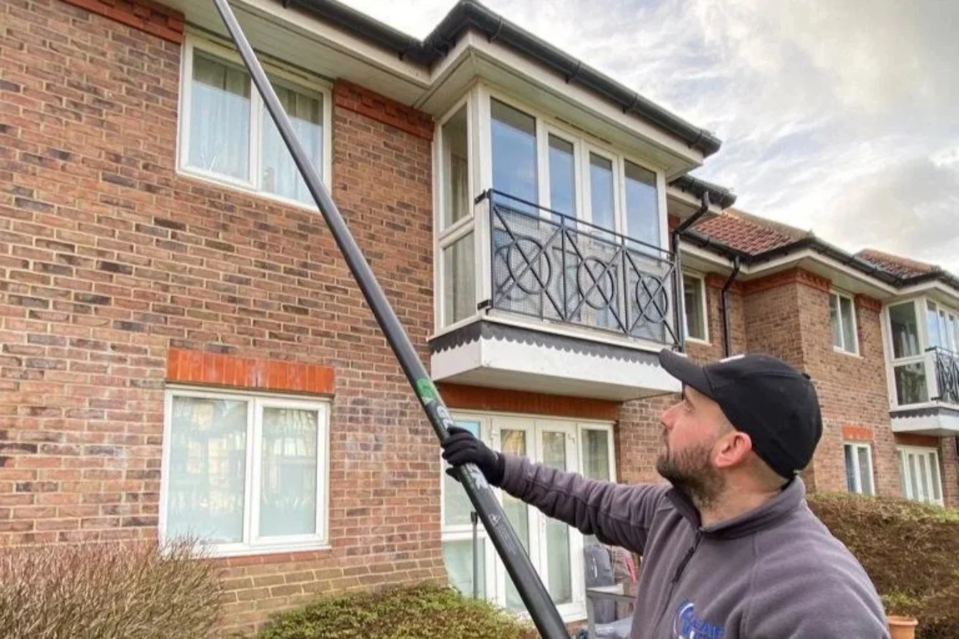 Clearview operative using a Gutter-Vac pole system to clear gutters from the ground