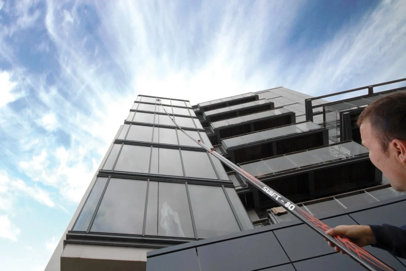 Clearview operative using a Reach and Wash water-fed pole to clean high-level windows in London