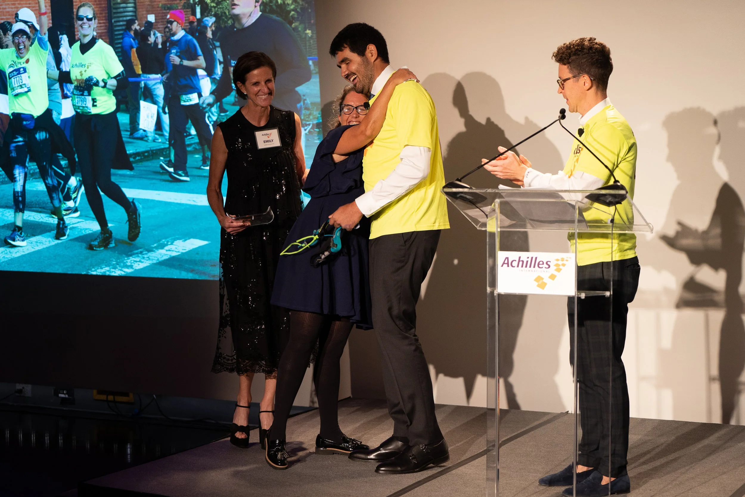  Sarah Heller, Achilles honoree, receiving her award and hugging Francesco Magisano 