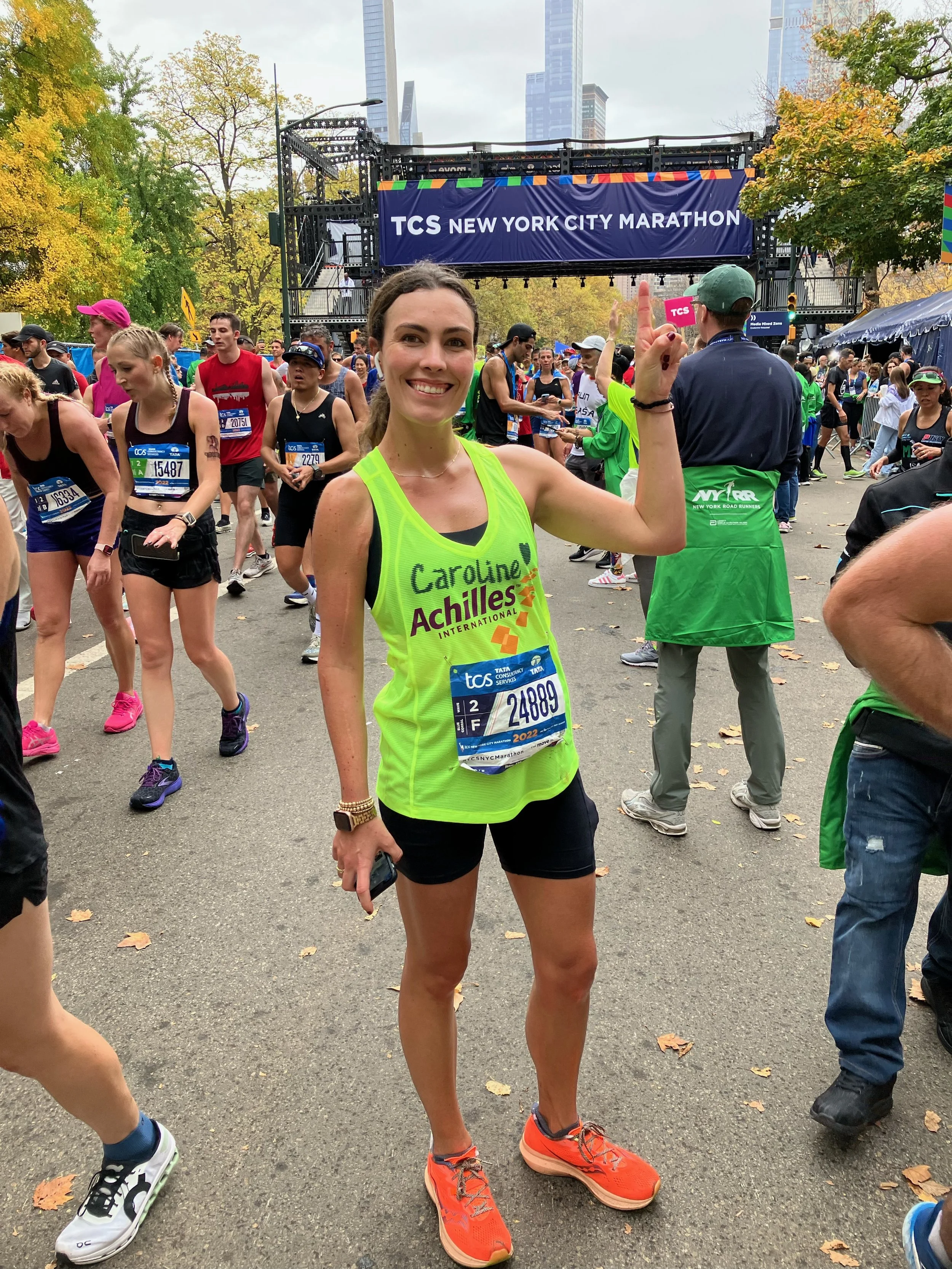  Top Team Achilles fundraiser Caroline Reilly posing at the finish line of the NYC Marathon 