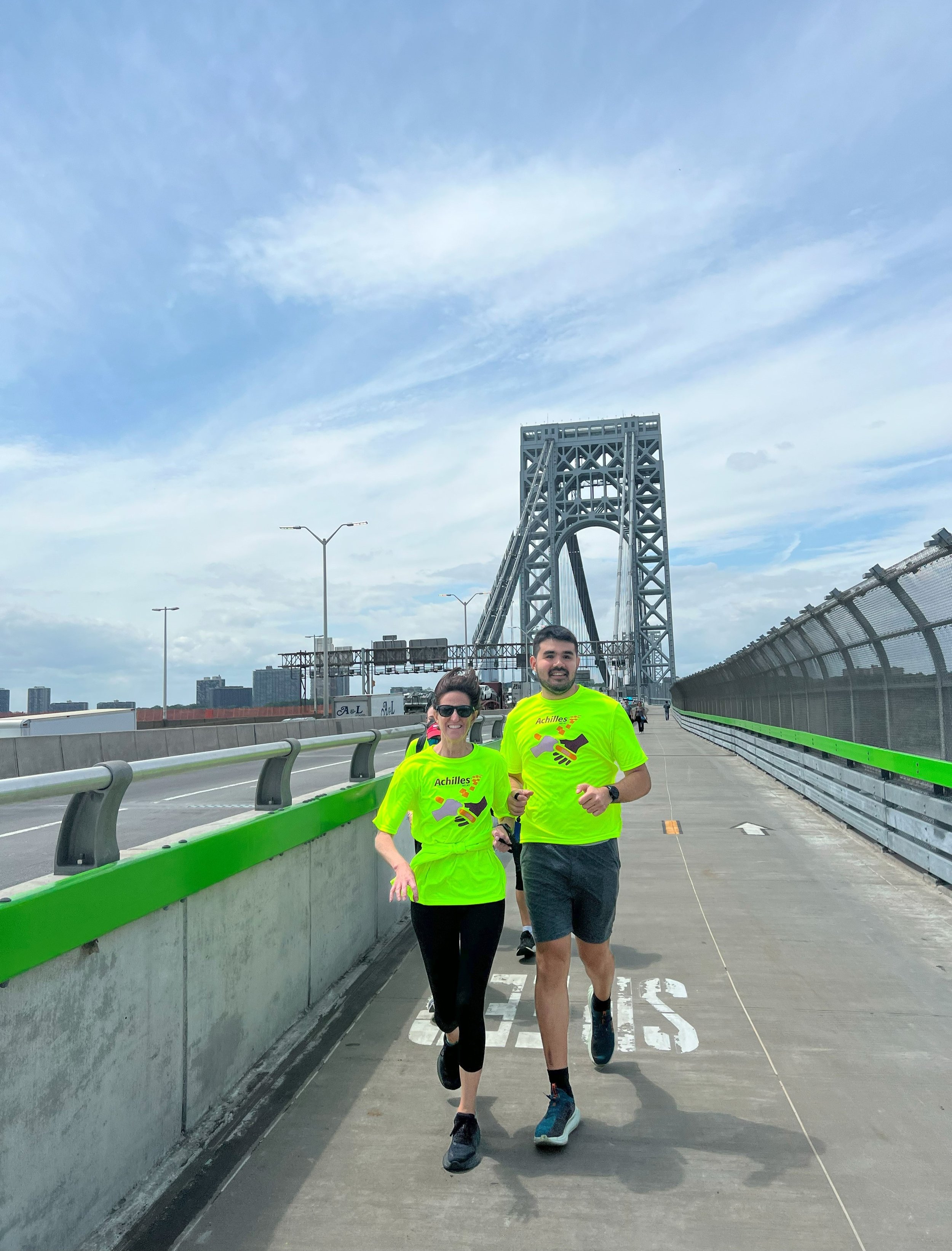 Emily Glasser, President and CEO of Achilles International, guiding Francesco Magisano, Director or NYC Metro, across the George Washington Bridge  