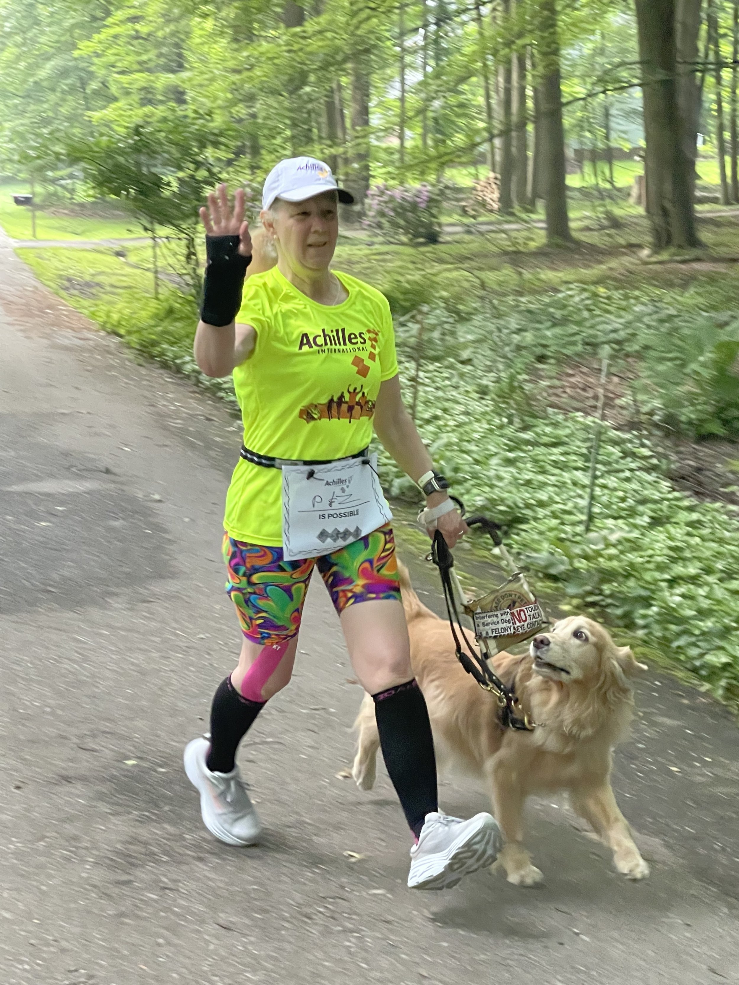  Team Achilles USA member on a walk with her guide dog 