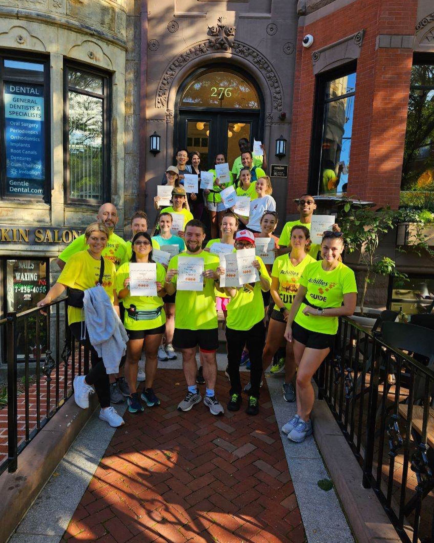  Members of Achilles Boston at their Hope and Possibility workout holding their Achilles branded fill in the blank signs.  