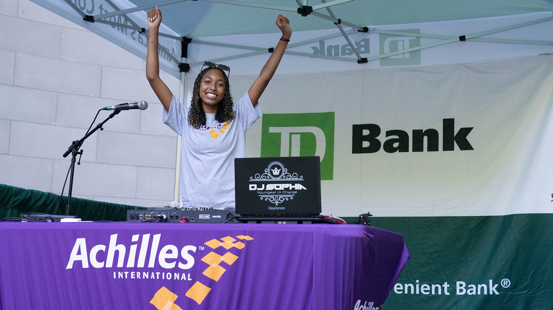  Photo of DJ Sophia Rocks cheering at her booth at the Bandshell celebration 
