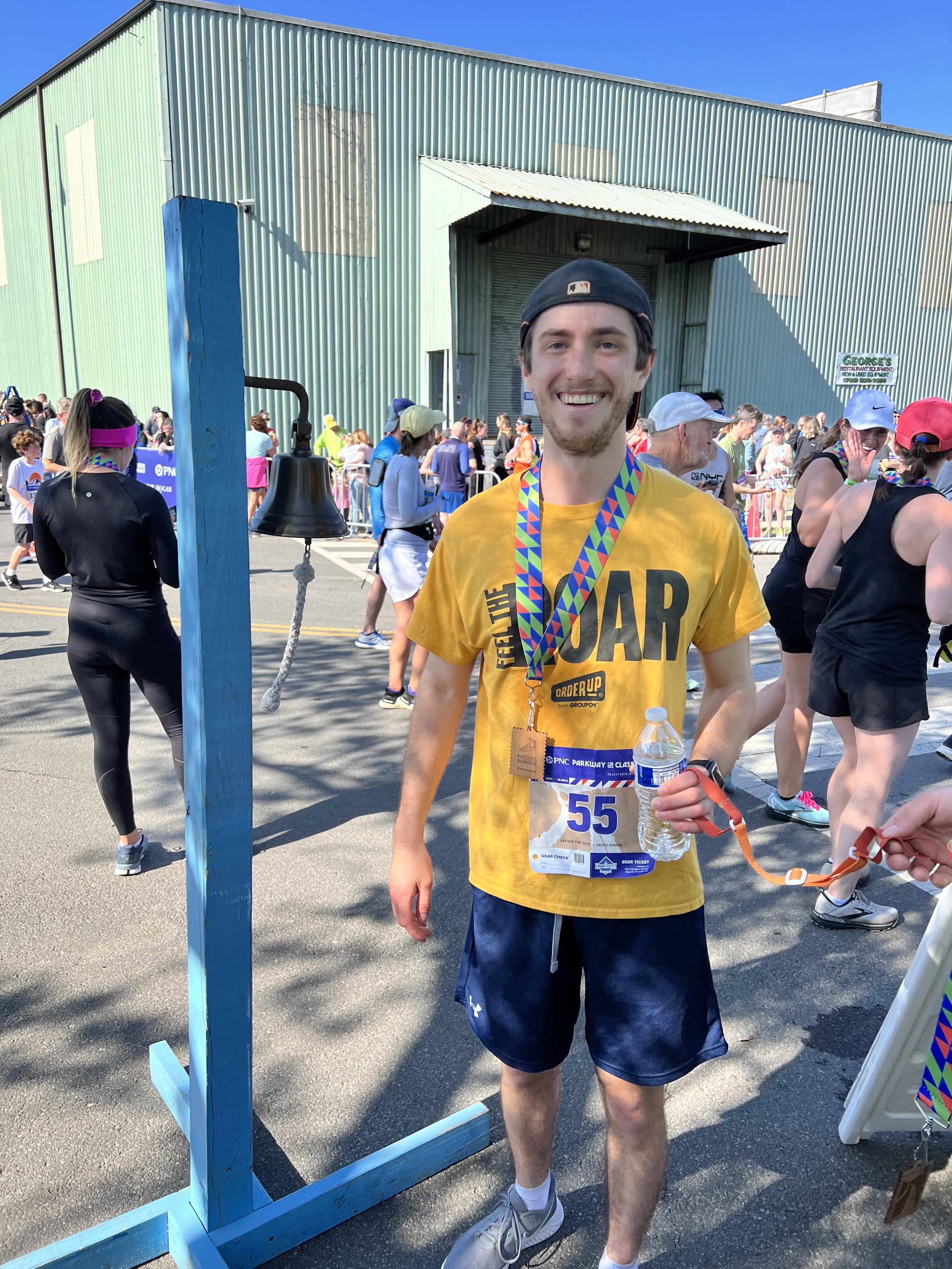  Photo of Tim smiling with his race medal 