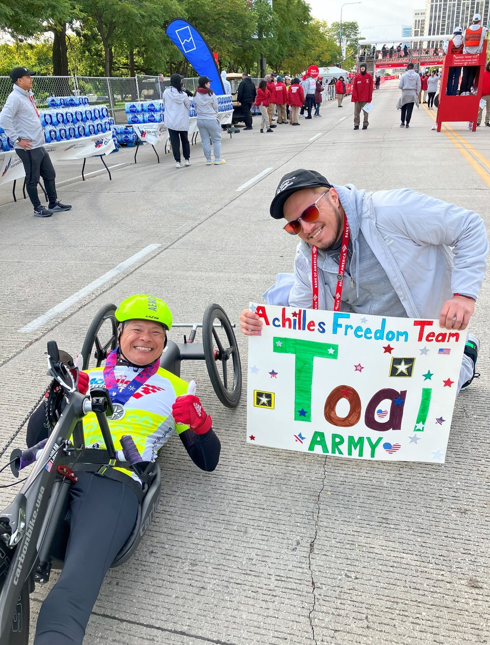  Achilles Freedom Team member, Toai, posing with a hand made sign cheering him on 
