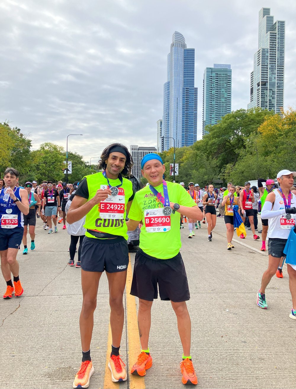  Raj Pannu and Achilles athlete Batzorig “Zoro” Baasai posing with their Chicago Marathon medals 