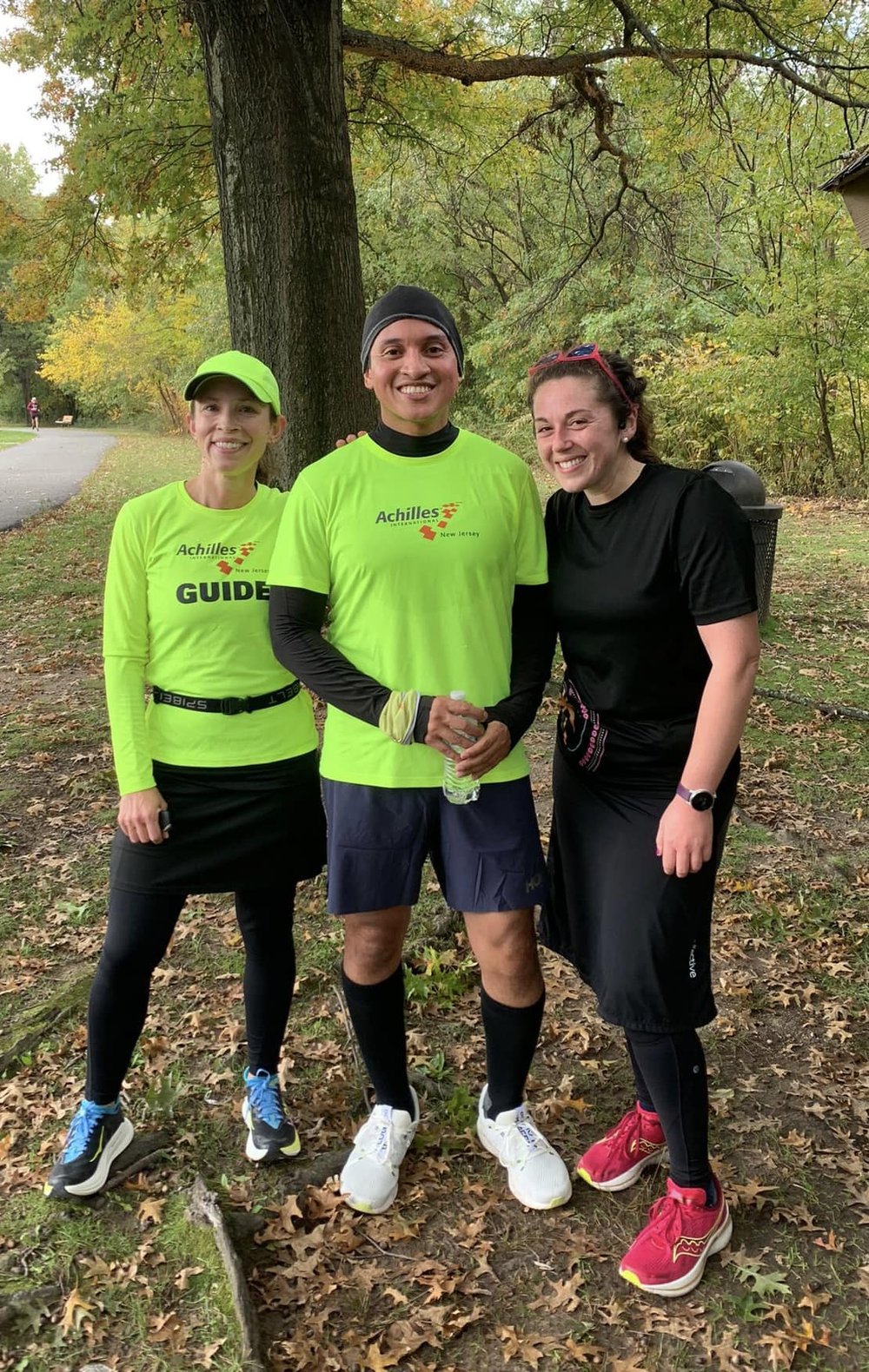  Rolando smiling and posing in between two Achilles New Jersey guides  