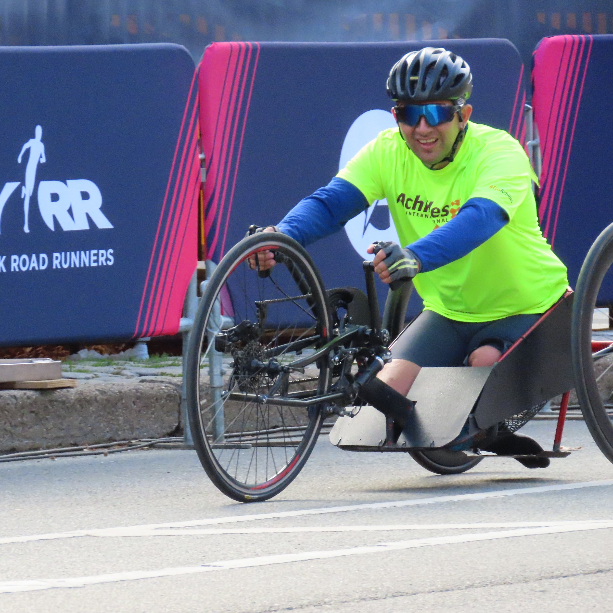  Achilles athlete smiling on his handcycle on the course  