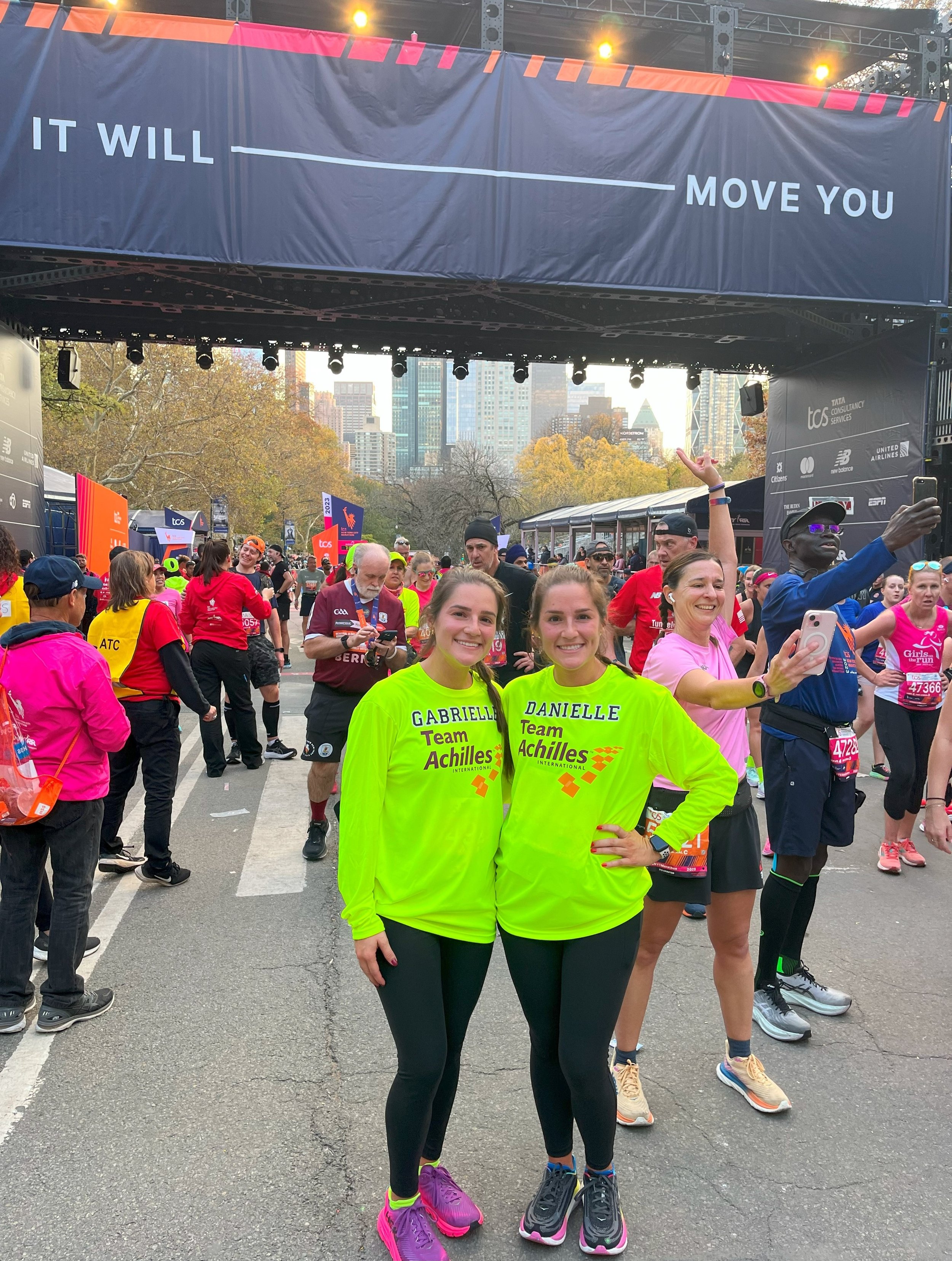  Team Achilles members posing together at the finish line 