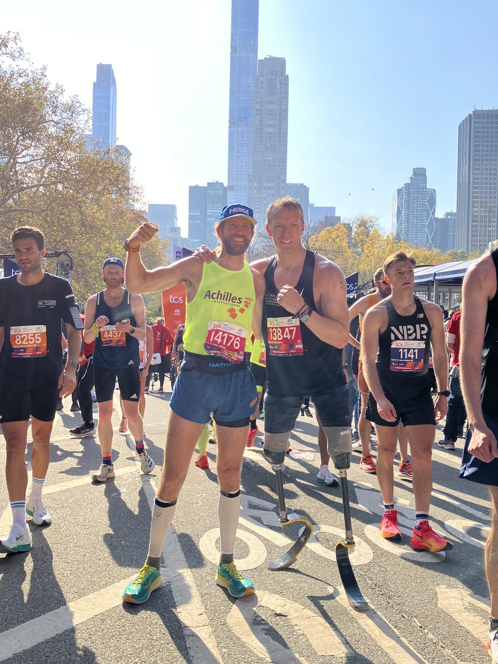 Mike Wardian and Richard Whitehead posing together at the NYC Marathon finish line  