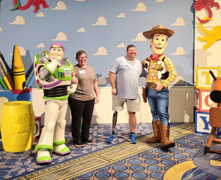  Achilles members posing with Disney Pixar characters Woody and Buzz from Toy Story 