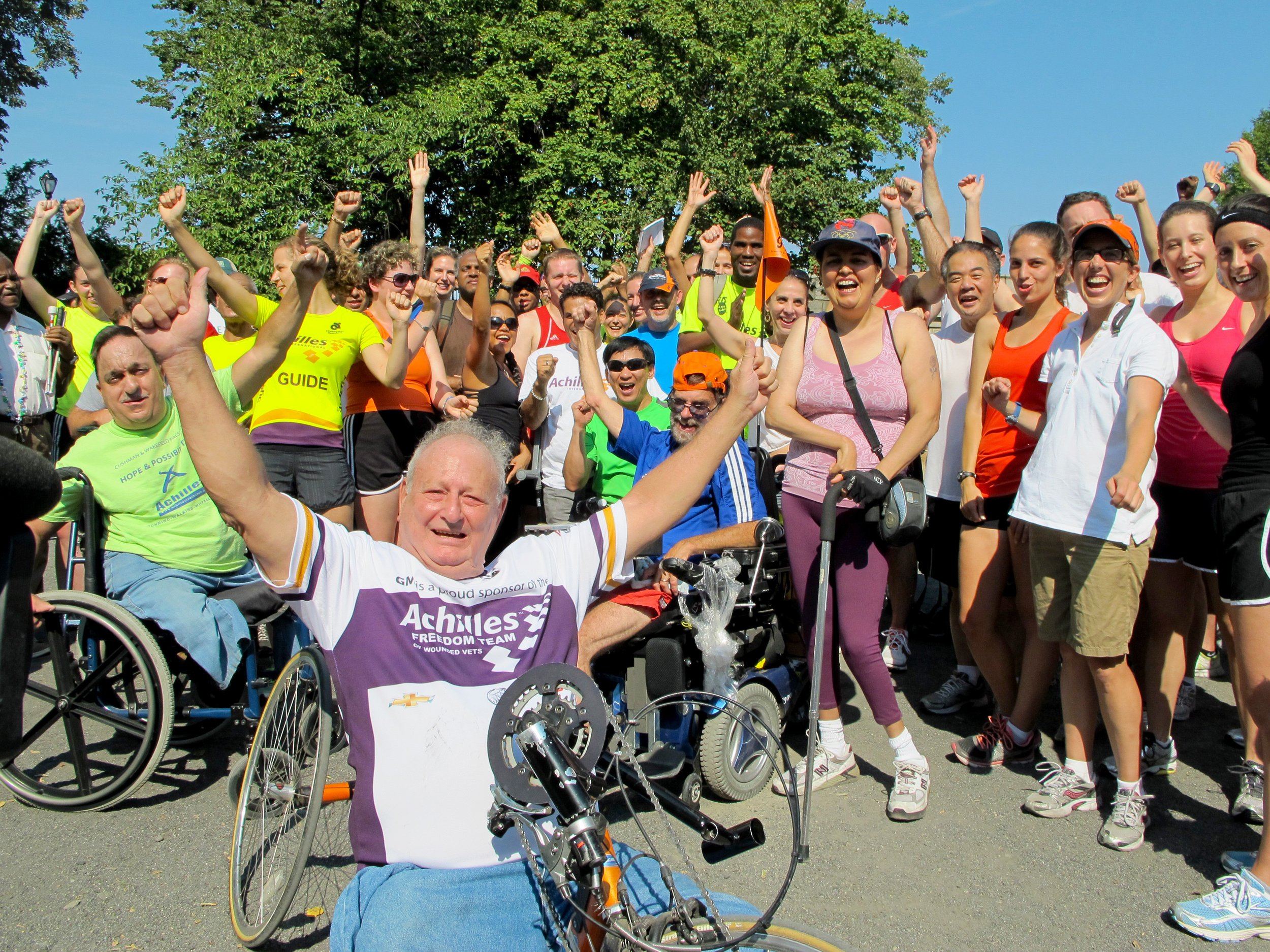  Dick Traum cheering with Achilles athletes and supporters  