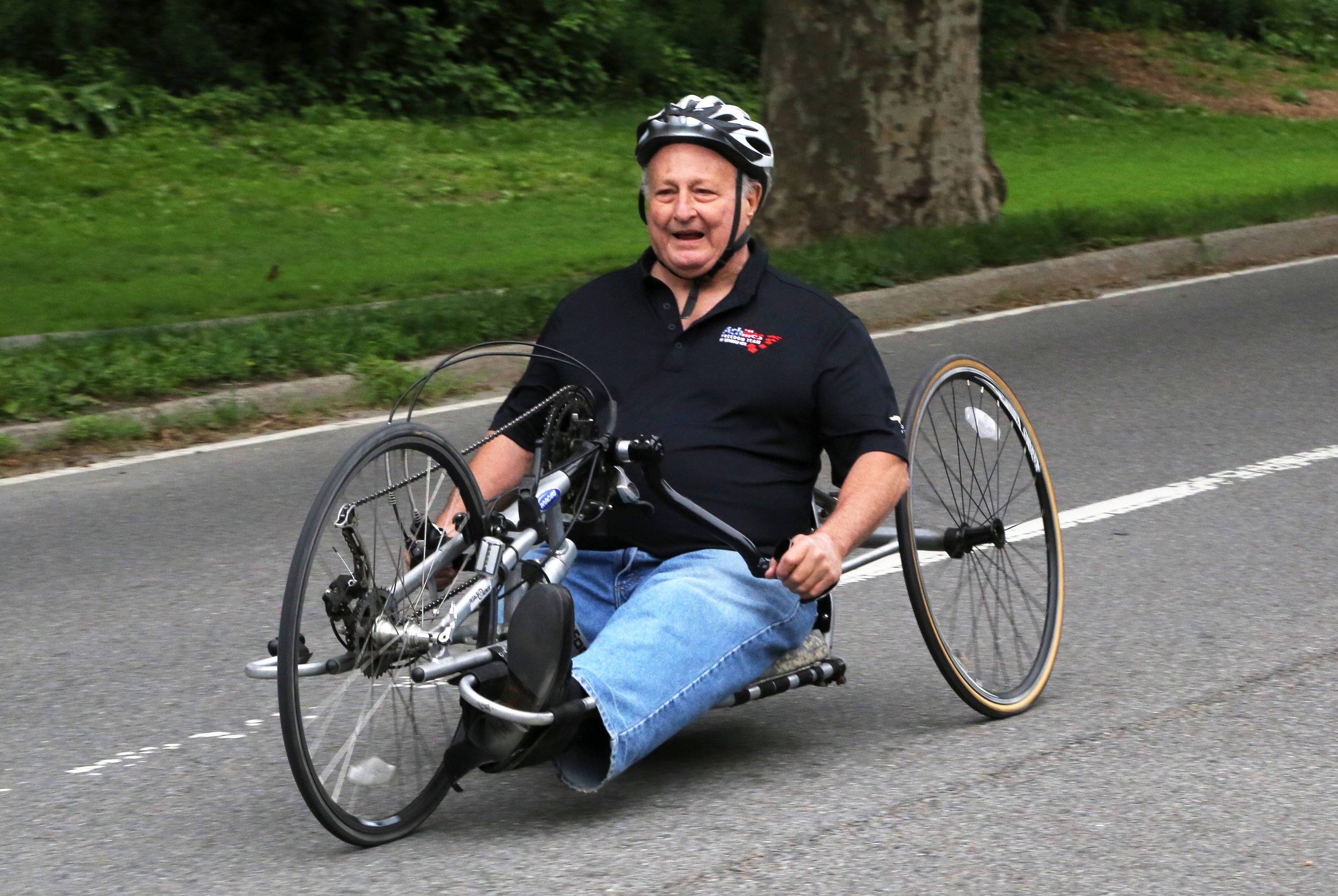  Dick Traum smiling while riding a handcycle 