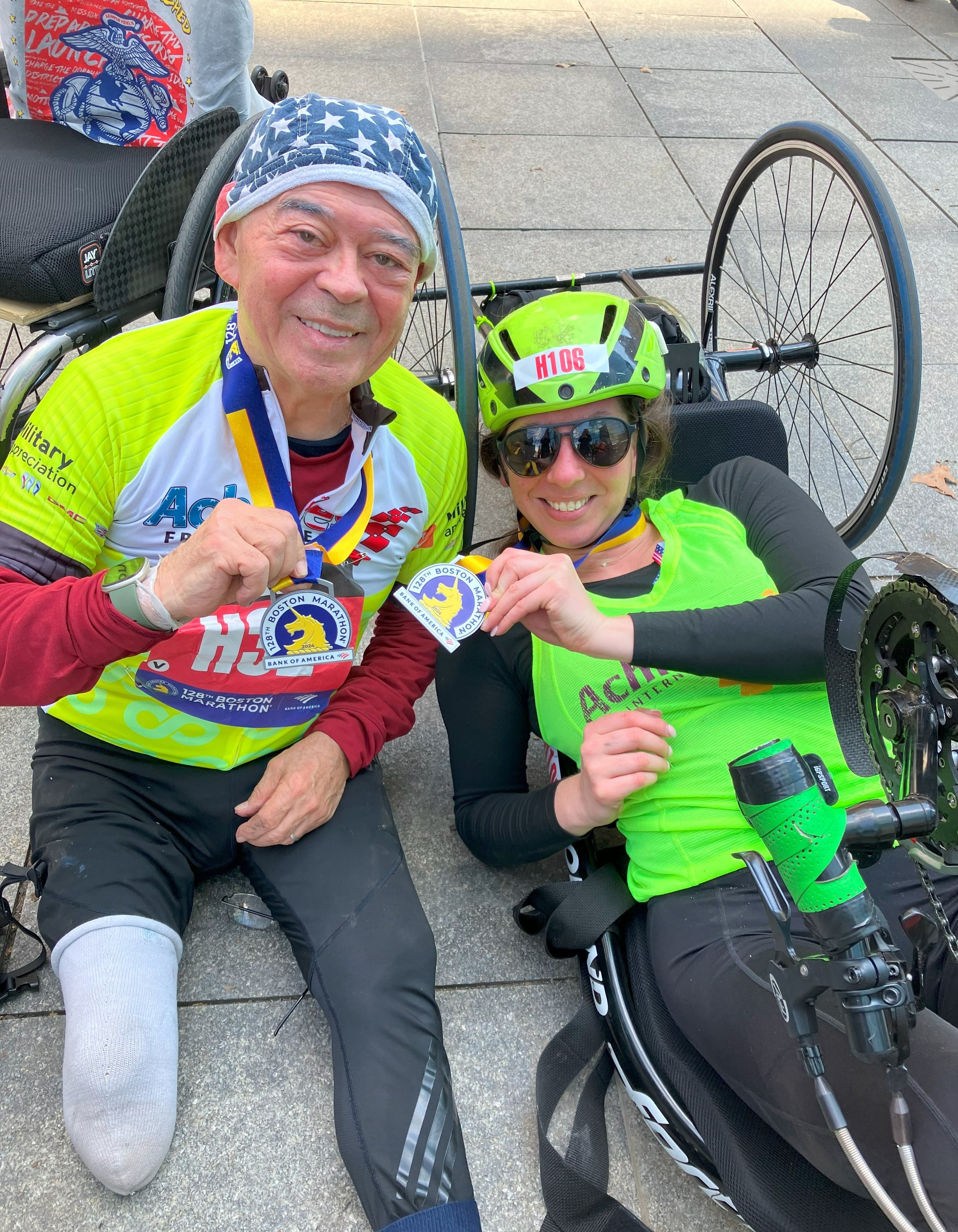  Achilles handcycle athletes smiling together with their medals 