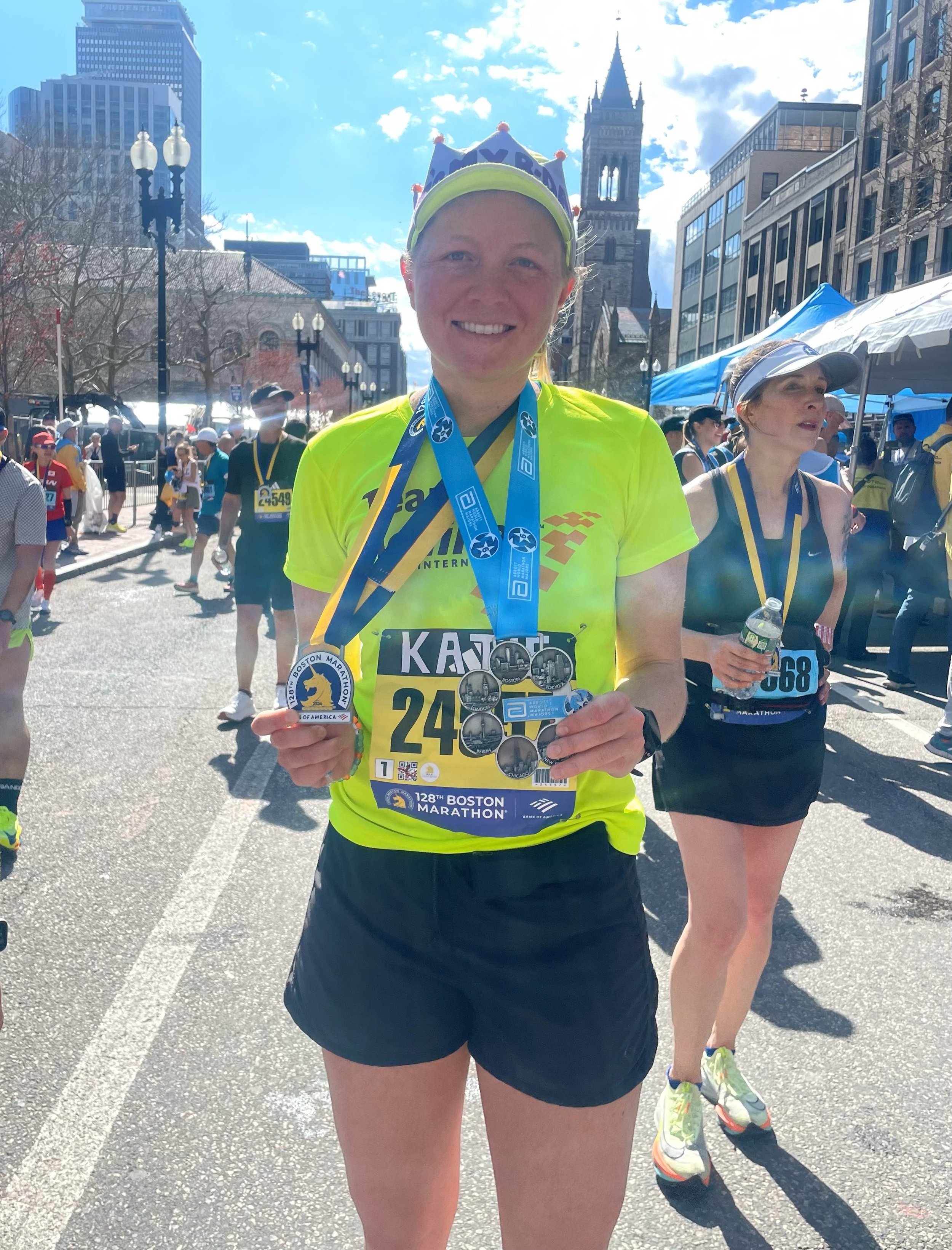 Katie Miller smiling with her birthday crown, her Boston Marathon medal, and her Abbott World Marathon Majors medal 