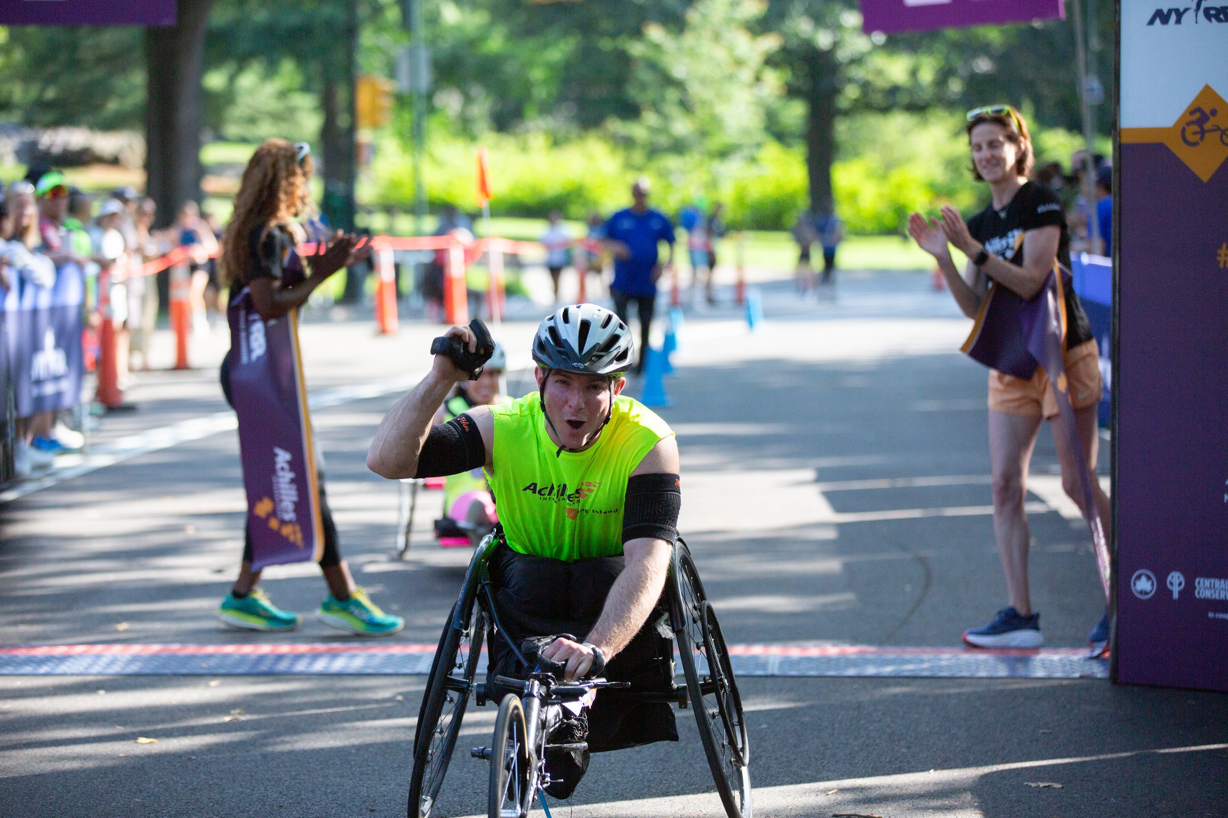 Michael LaRose cheering as he crosses the finish line.