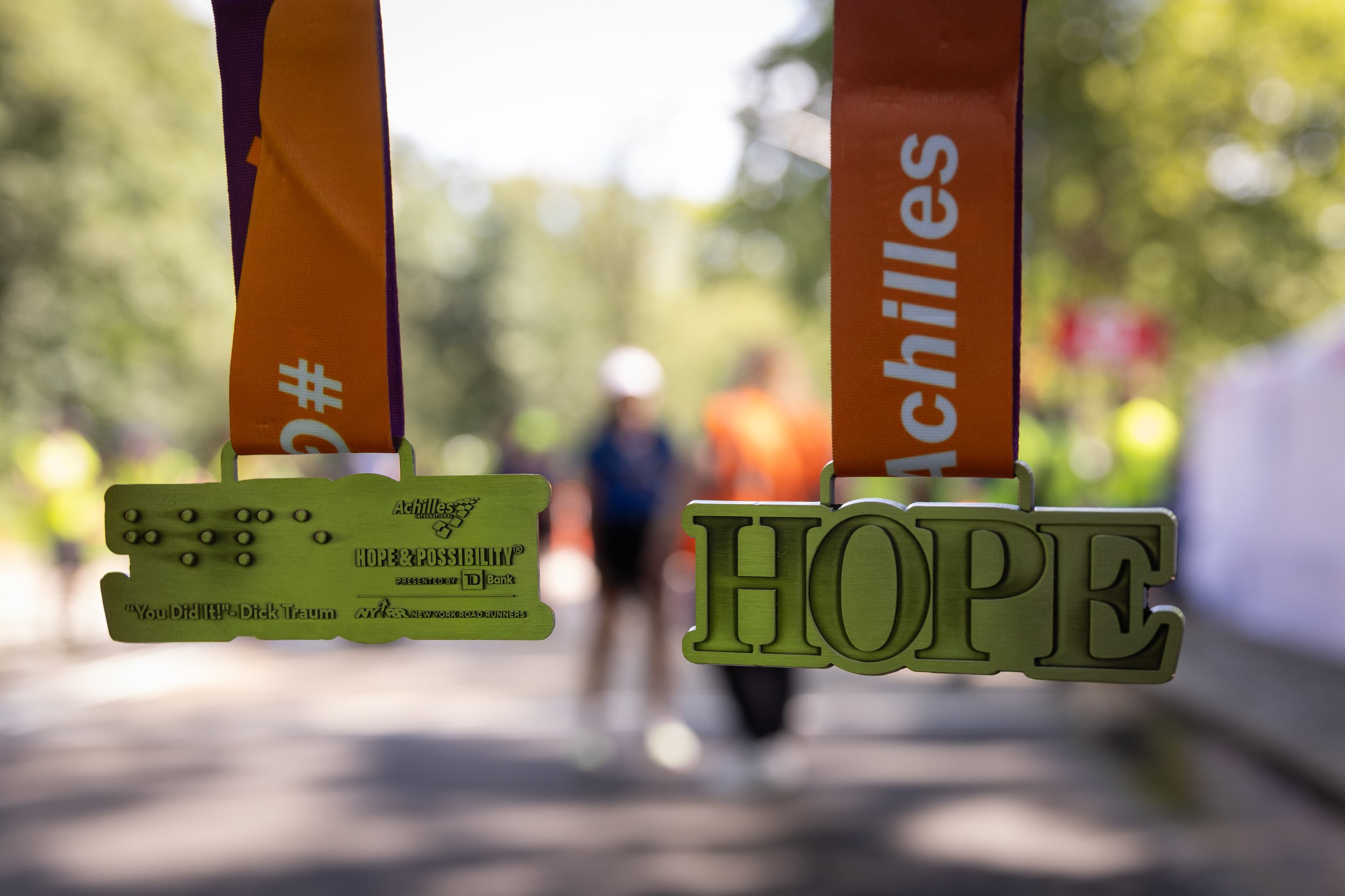 The front and back of the Hope & Possibility medal.