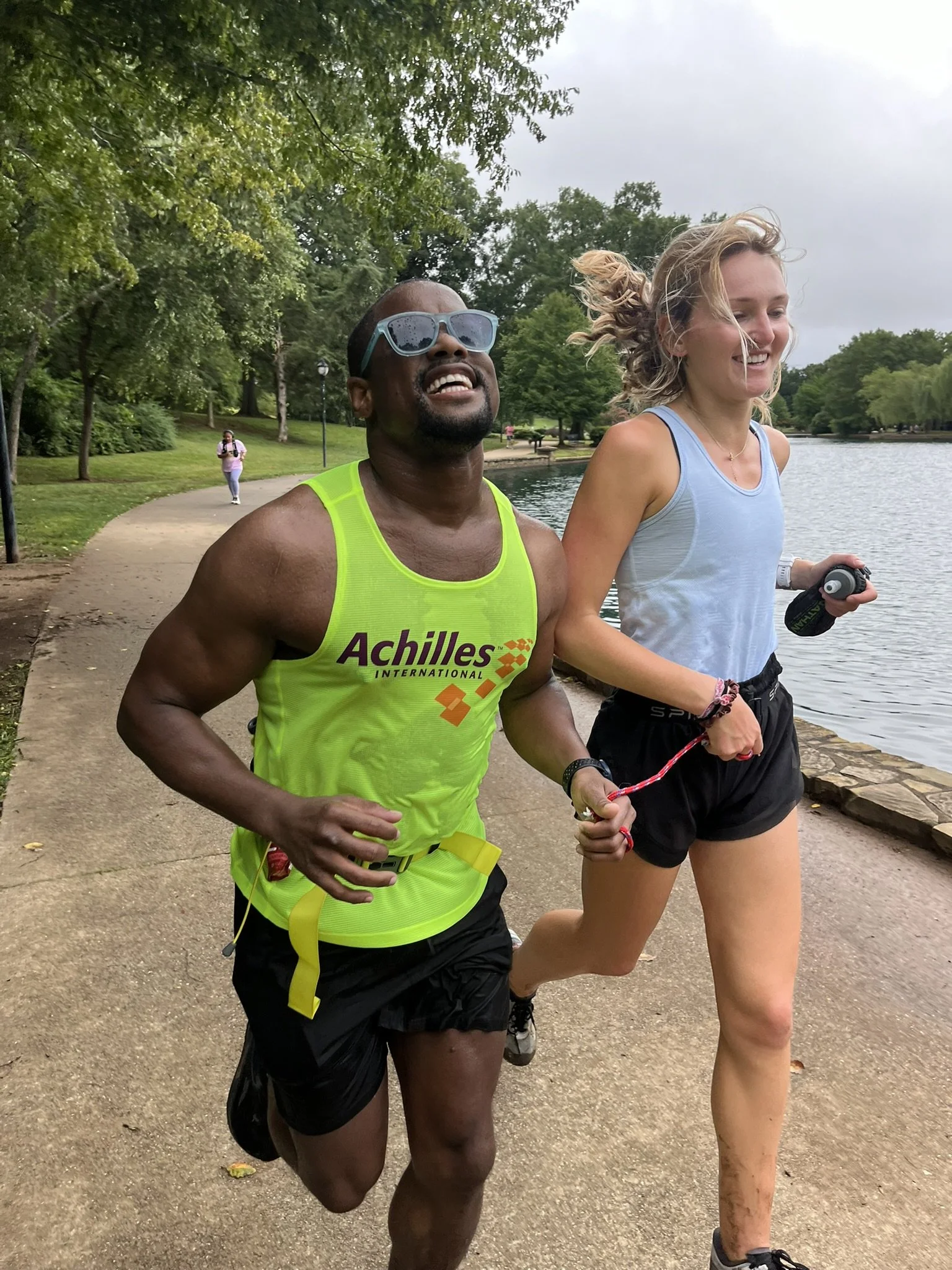  DJ running and smiling alongside his guide 
