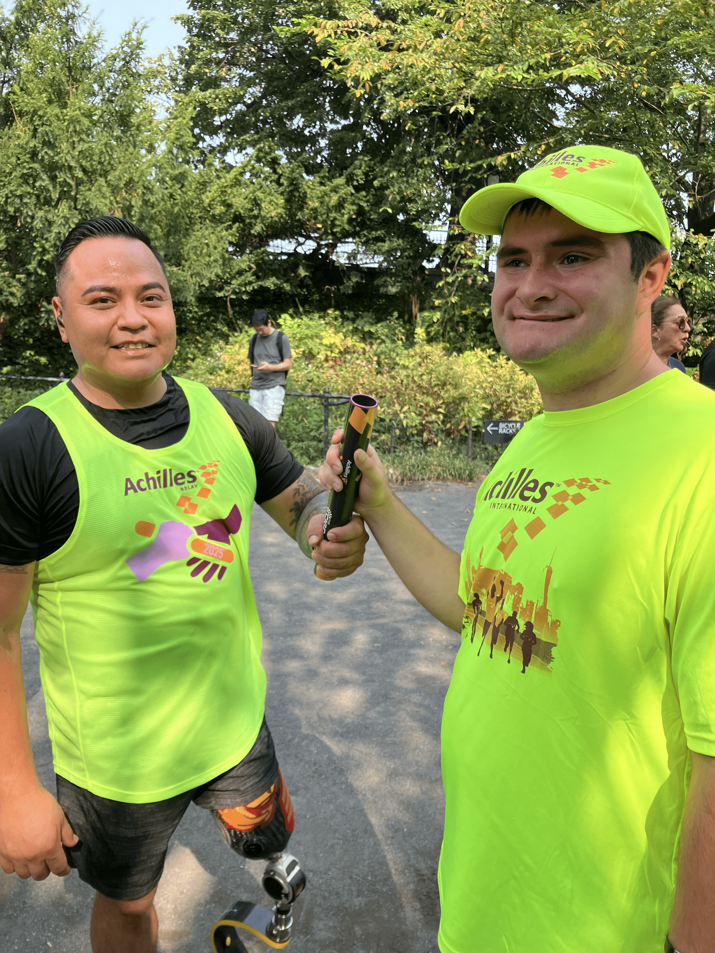 The Relay baton being passed to a member of Achilles NYC.