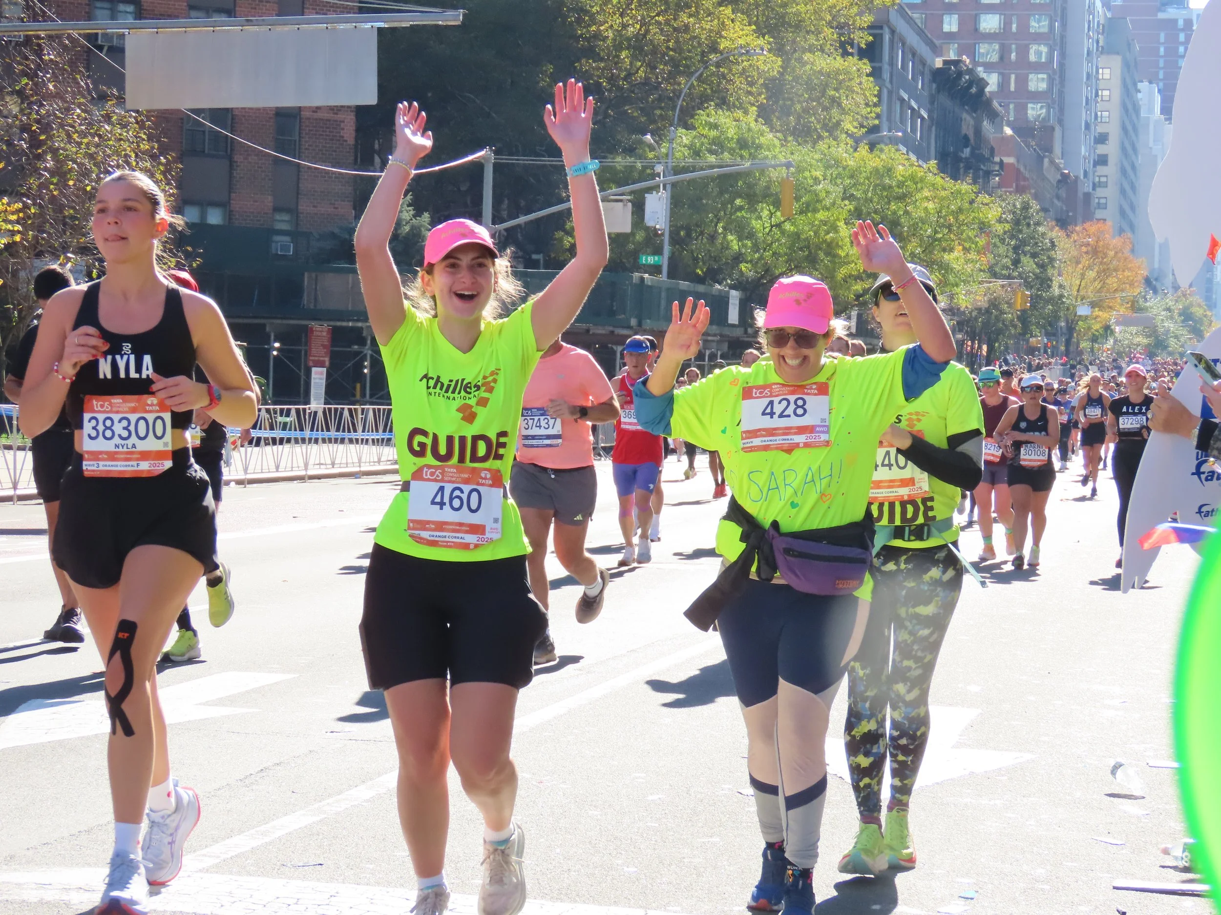  Achilles athlete smiling and cheering with her guide on the course.  