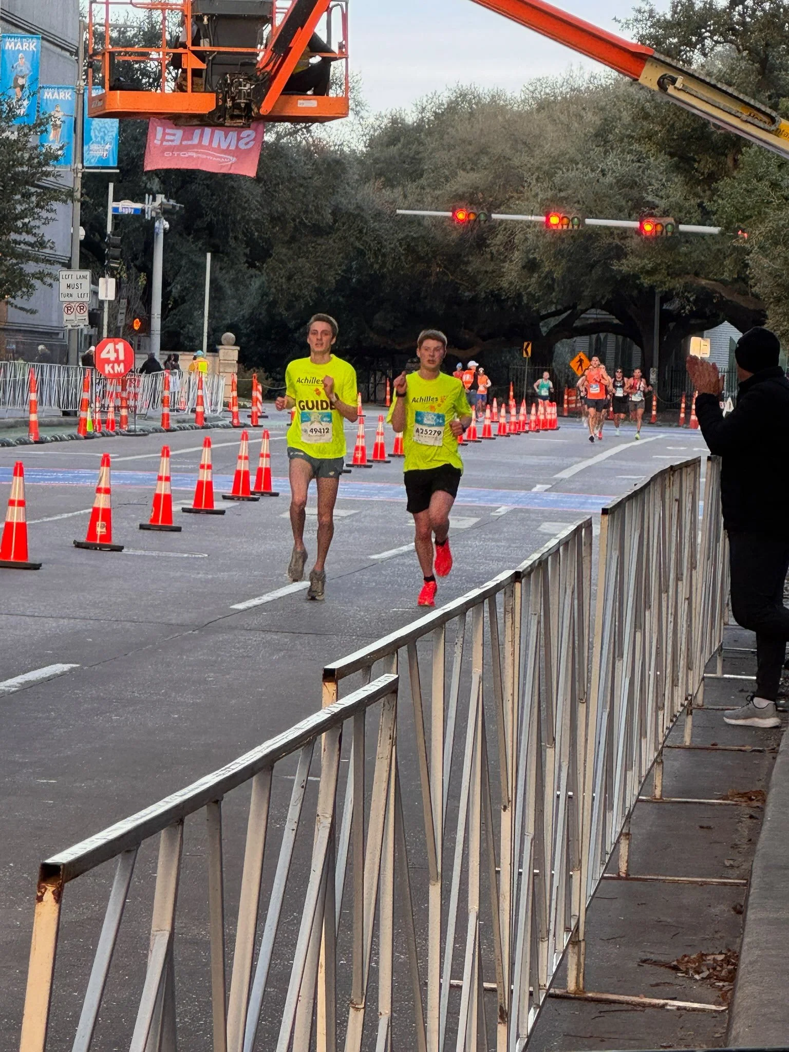  Achilles athlete running with their guide.  