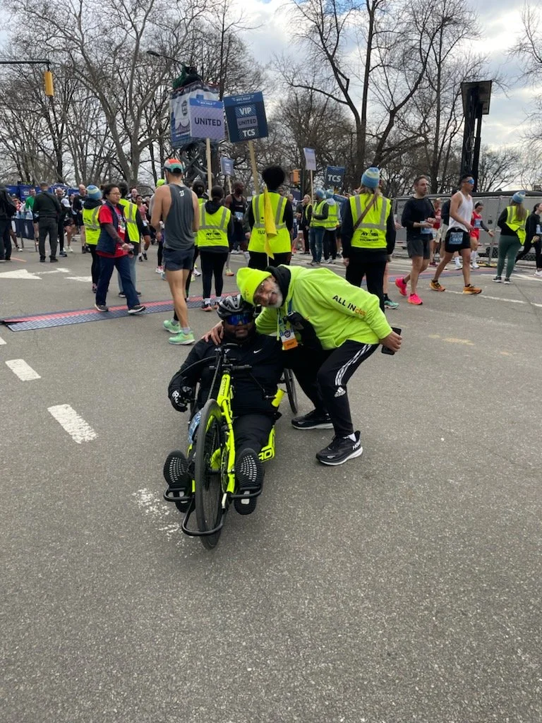  Suraj posing on his handcycle with a fellow Achilles athlete.  