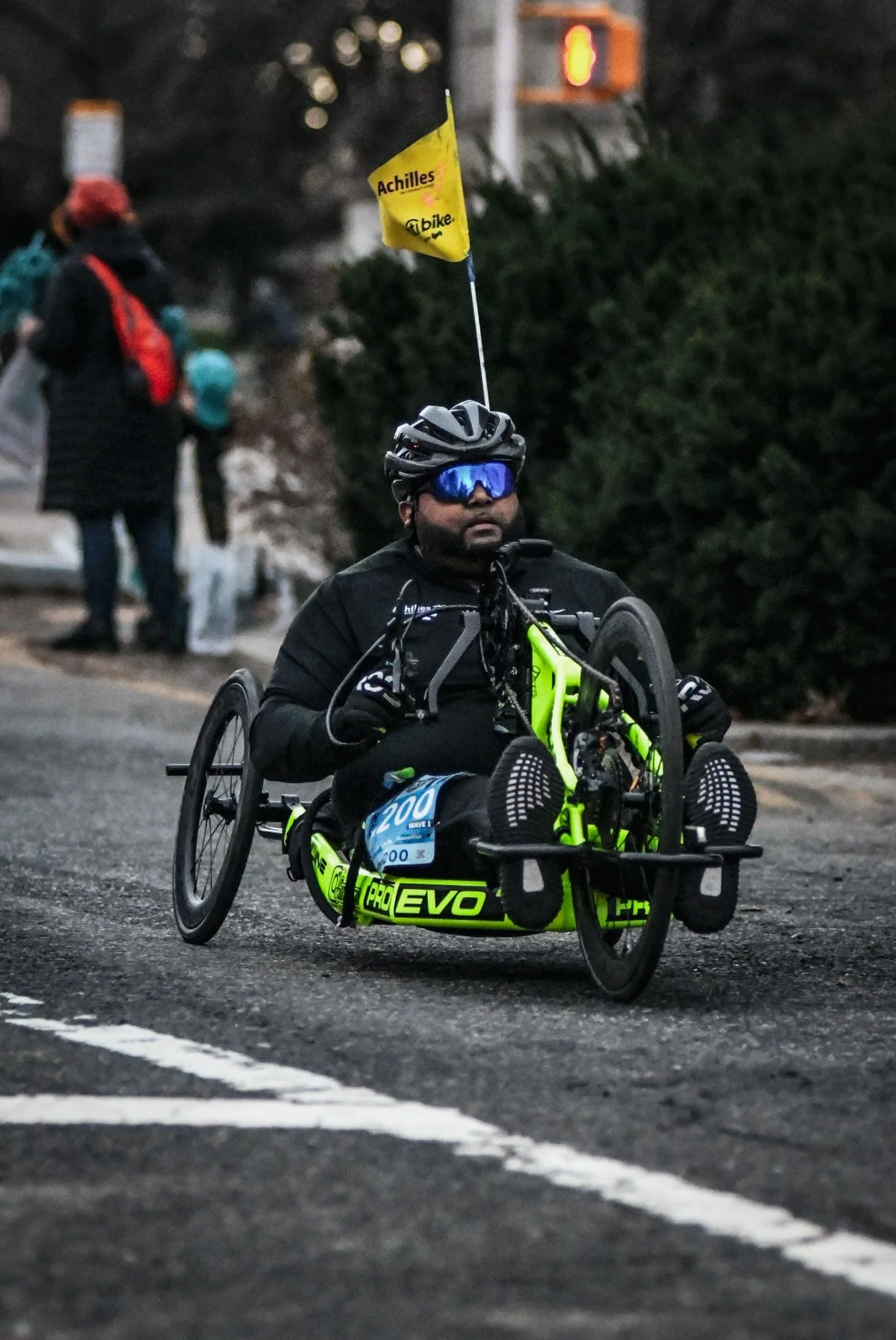 Suraj riding his handcycle on a race course.  