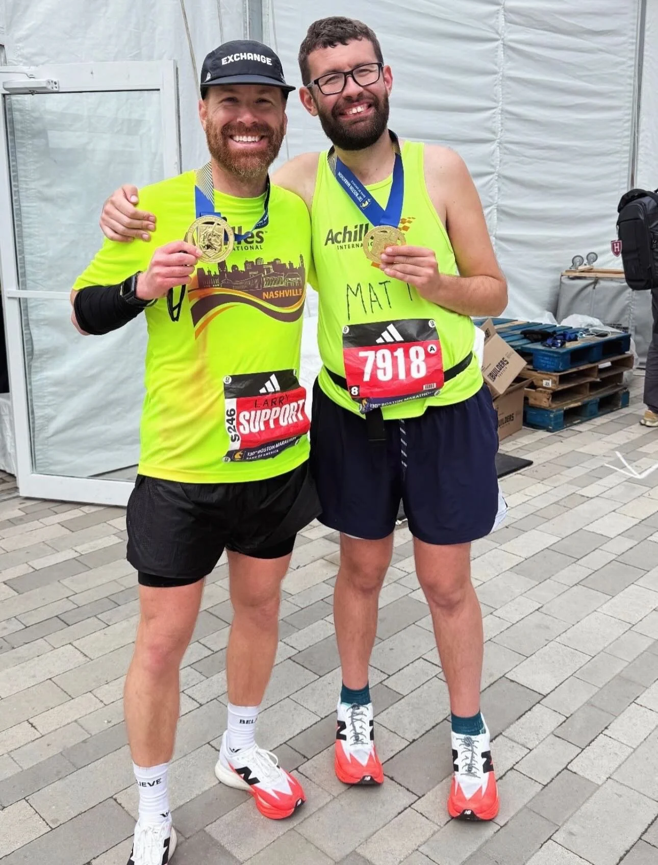  Achilles Nashville athlete smiling with his guide and their race medals.  